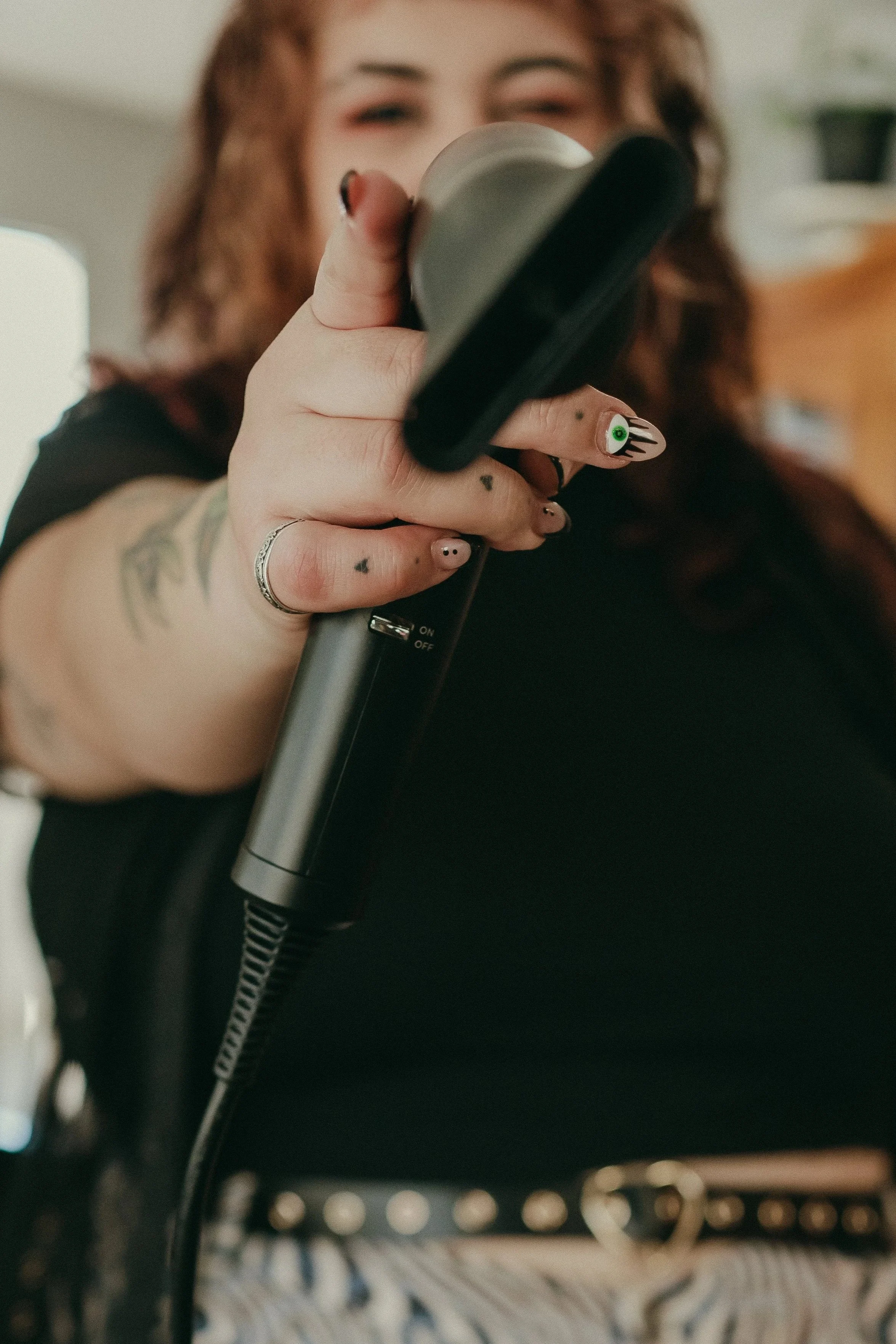 Owner and stylist, Allison Bowers being cute as heck with her blow dryer pointed at the camera.