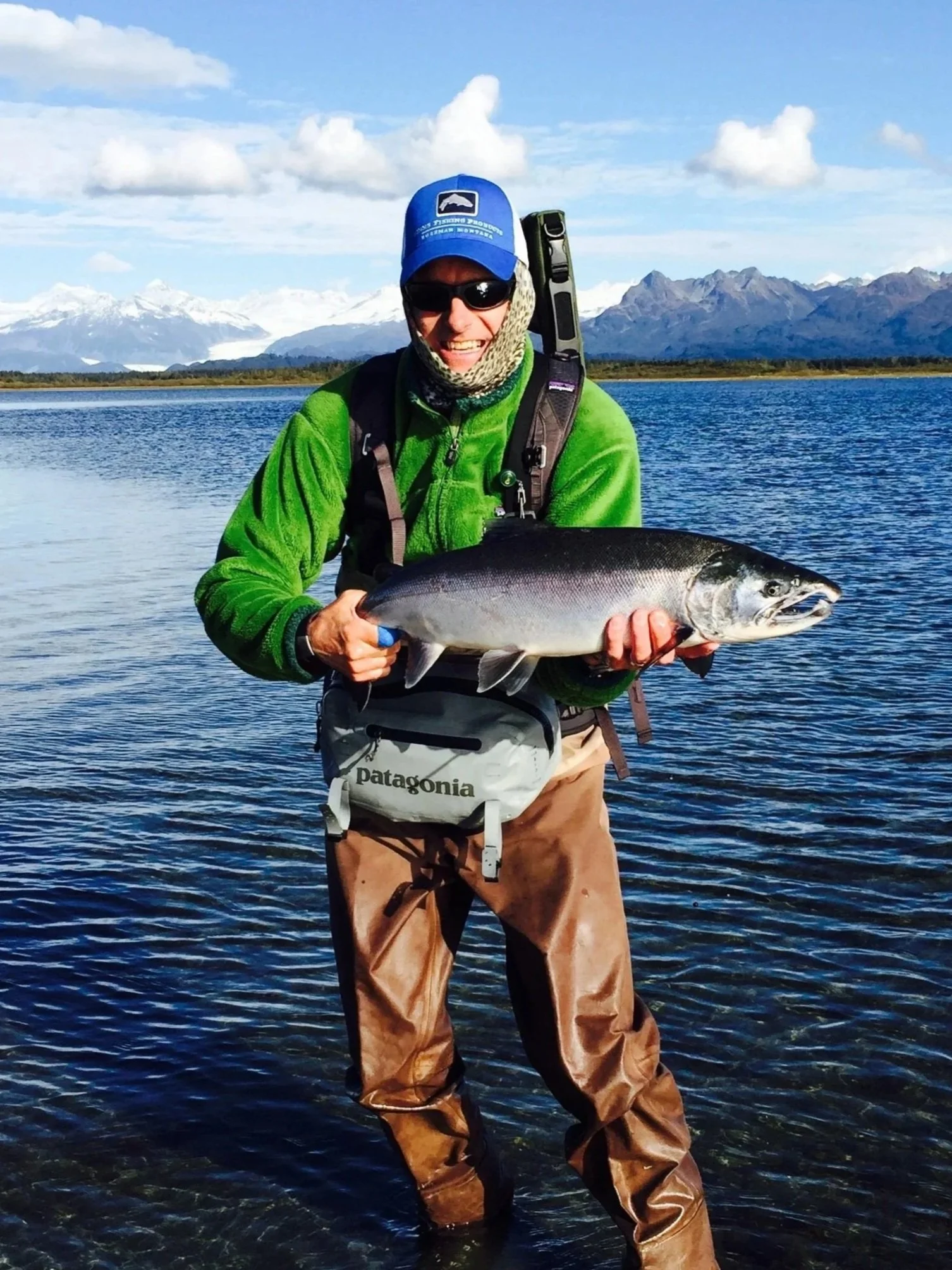 man holding silver salmon caught with a kokanee UV lure
