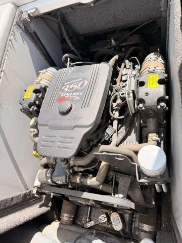Outboard motor engine with 350 MAG MPI label and Yamaha logo in boat compartment.
