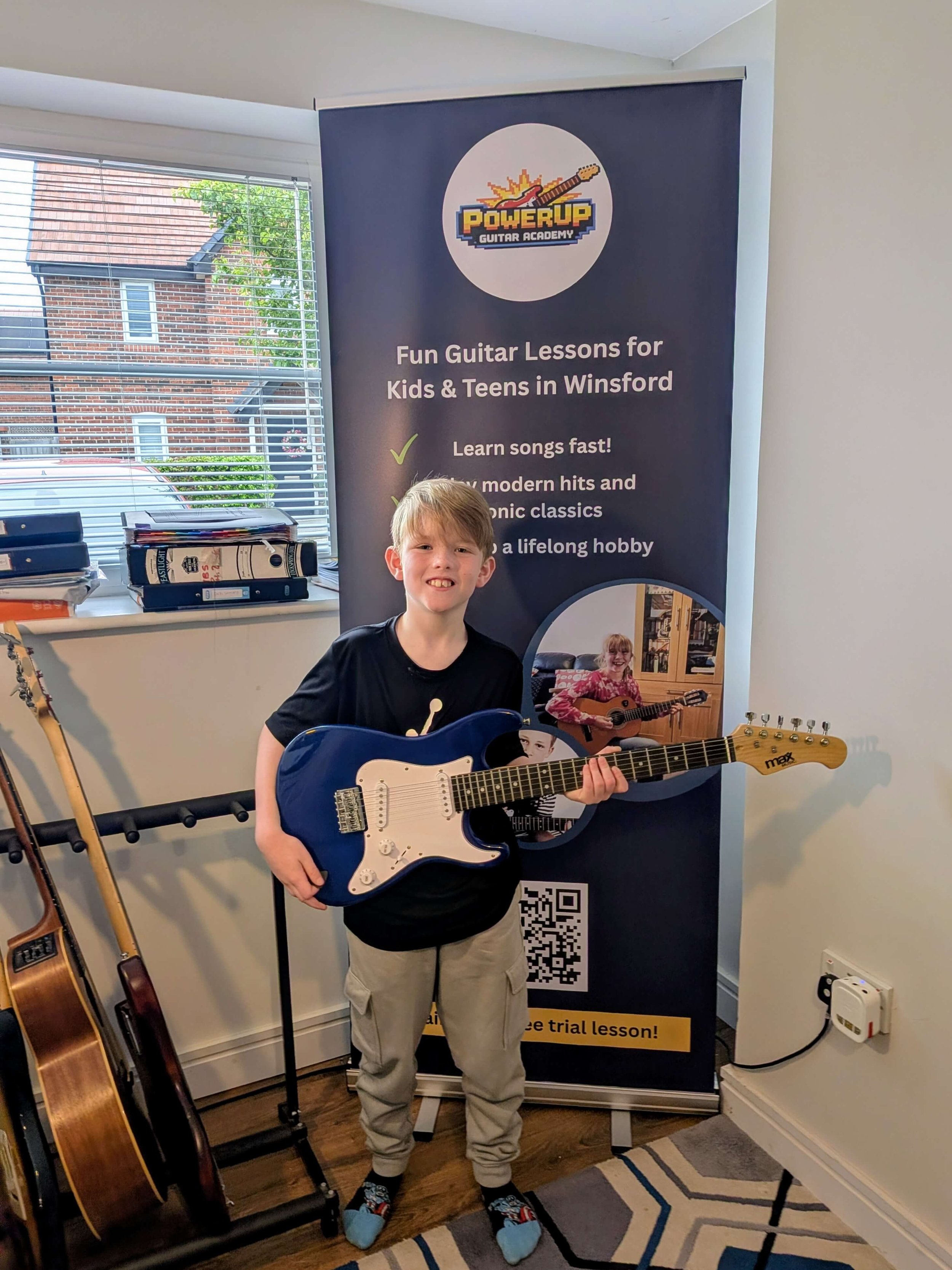 Kids playing electric guitar in a fun lesson at PowerUp Guitar Academy Winsford