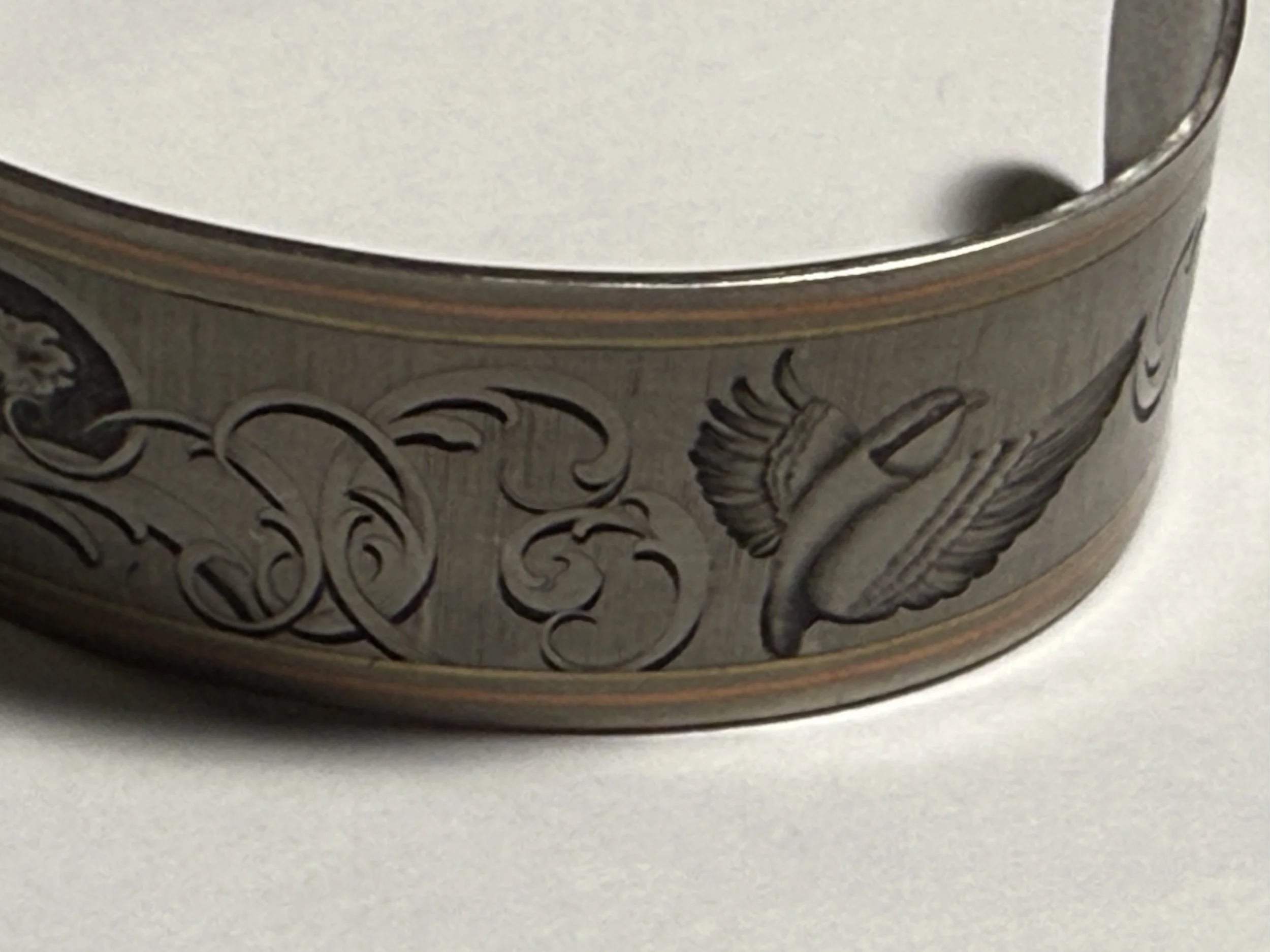 Hand-engraved hand crafted titanium cuff Bulino engraved birds with delicate scrolls.