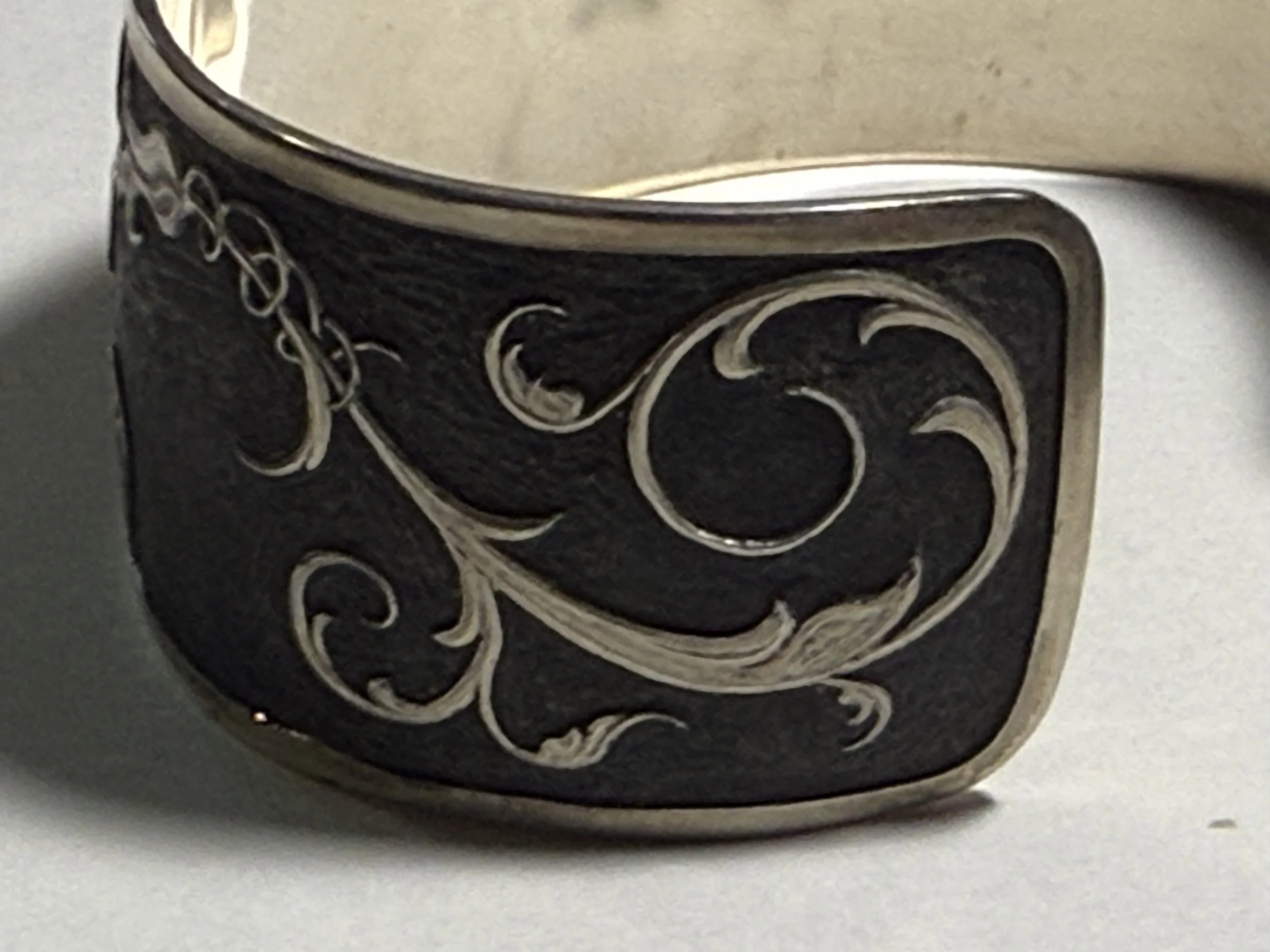 Hand-engraved sculpted scrolls on sterling silver cuff
