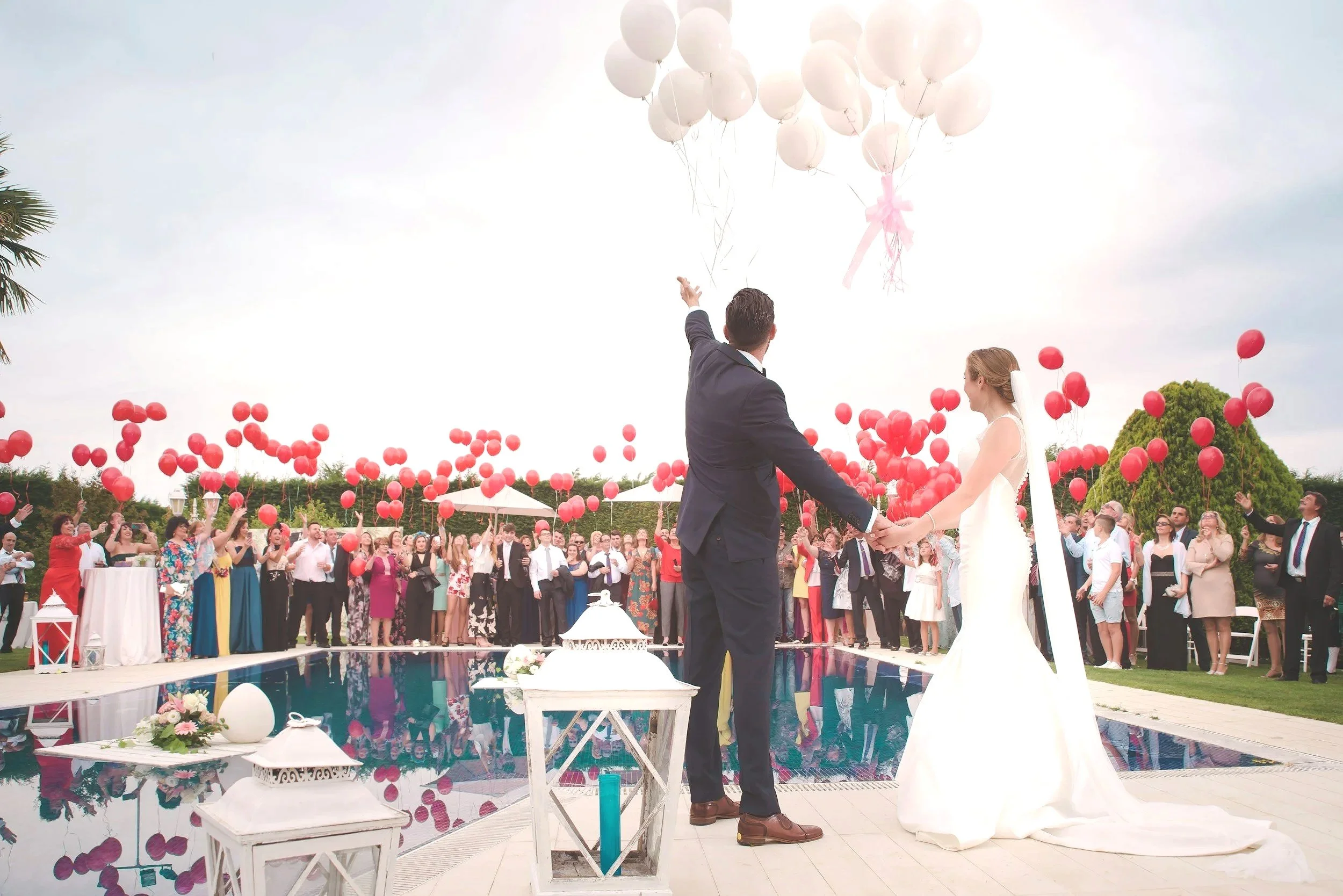 Wedding couple celebrating with guests outdoors after the ceremony