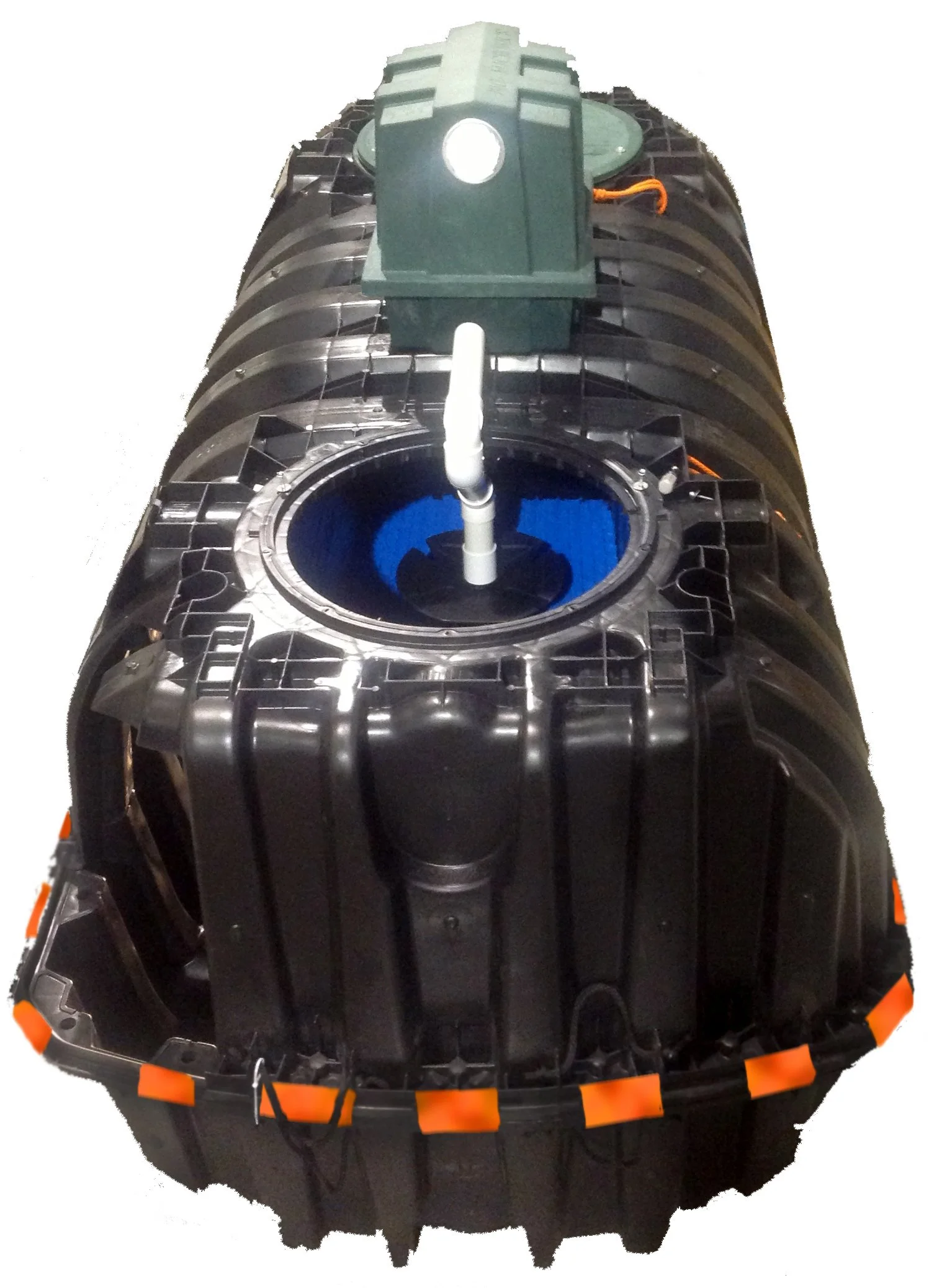 A large black, cylindrical robotic or industrial device with a central pipe extending upward; there is a green component on top with a circular opening. The device has an orange safety cover around its perimeter.