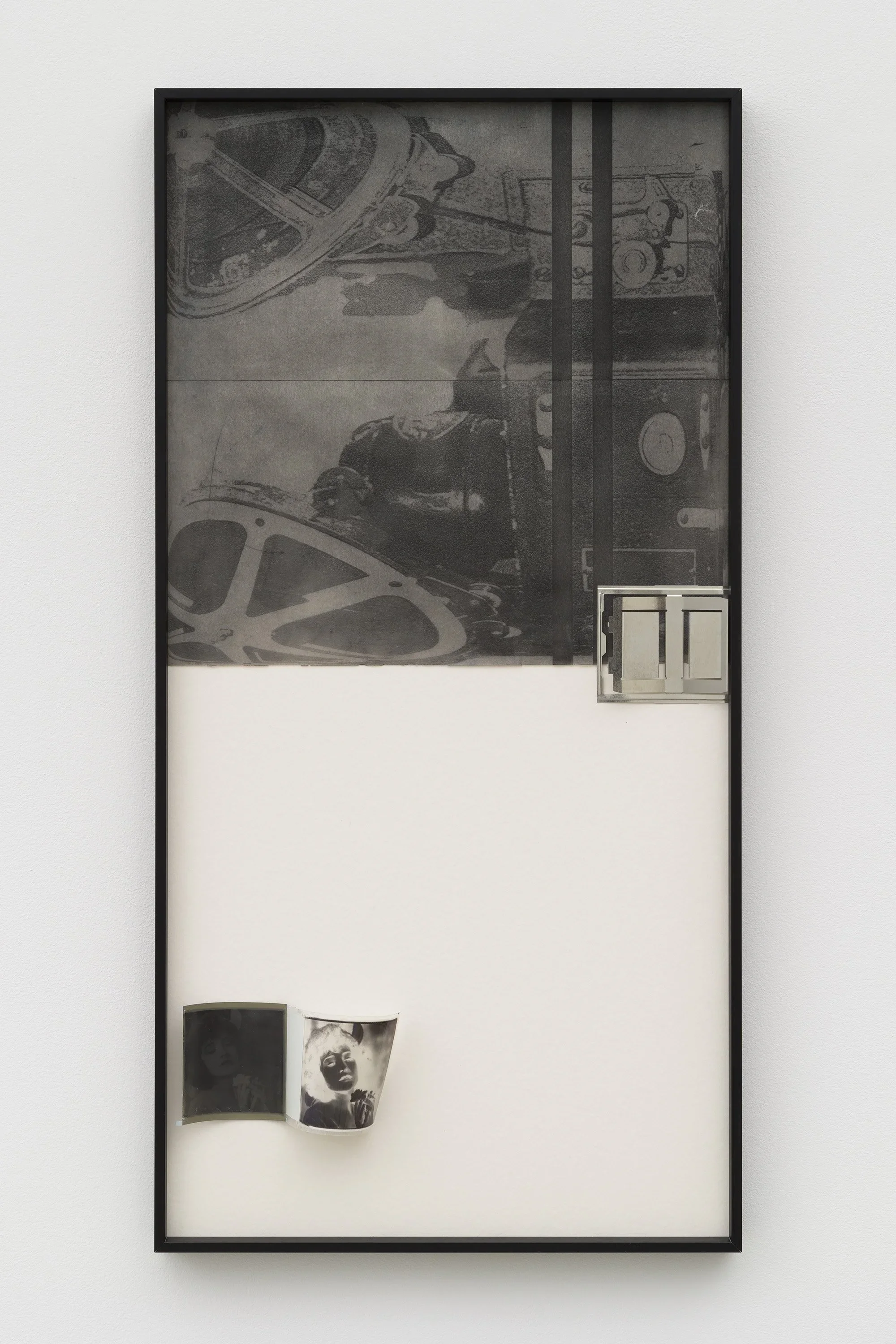 Art piece with black and white photographs, metal hardware, and film strips displayed in a vertical frame.