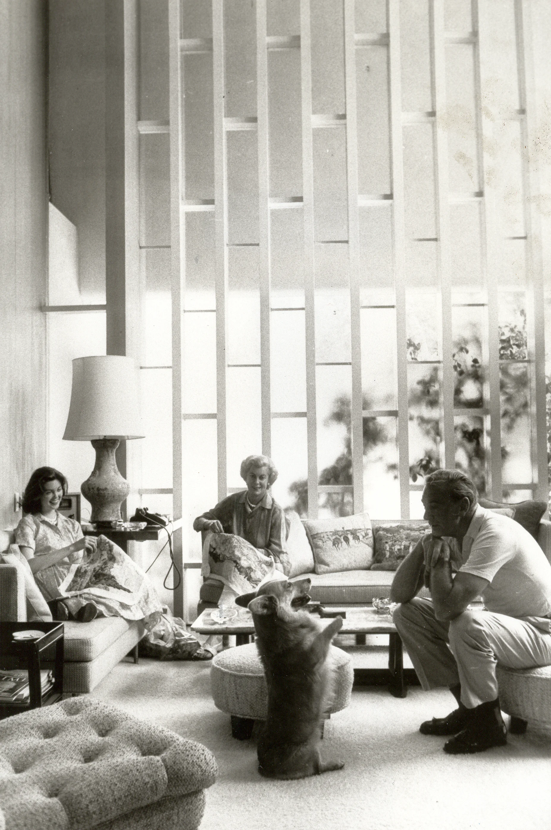 What an evening at home was like in our favorite corner of a very large living room where we relaxed, watched television, talked and played with our 4 footed friends, one of whom you see showing off for my father, while my mother and I worked on need