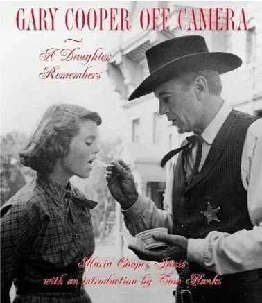 What daughter wouldn’t love that sweet moment captured in time?

It was on the location set of the iconic western movie "High Noon." My father is in costume as the Marshall of Hadleyville . The cast and crew were taking a much needed ‘break in shooti