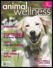 Magazine cover of Animal Wellness featuring a happy, white dog outside on green grass.