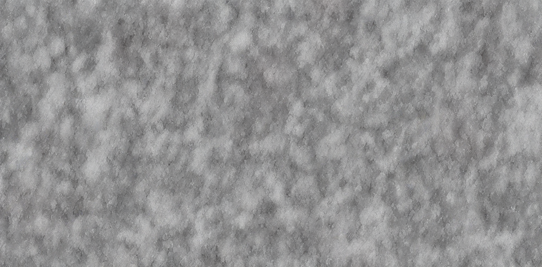 Close-up of a grey, textured, fluffy surface, possibly fabric or fleece.