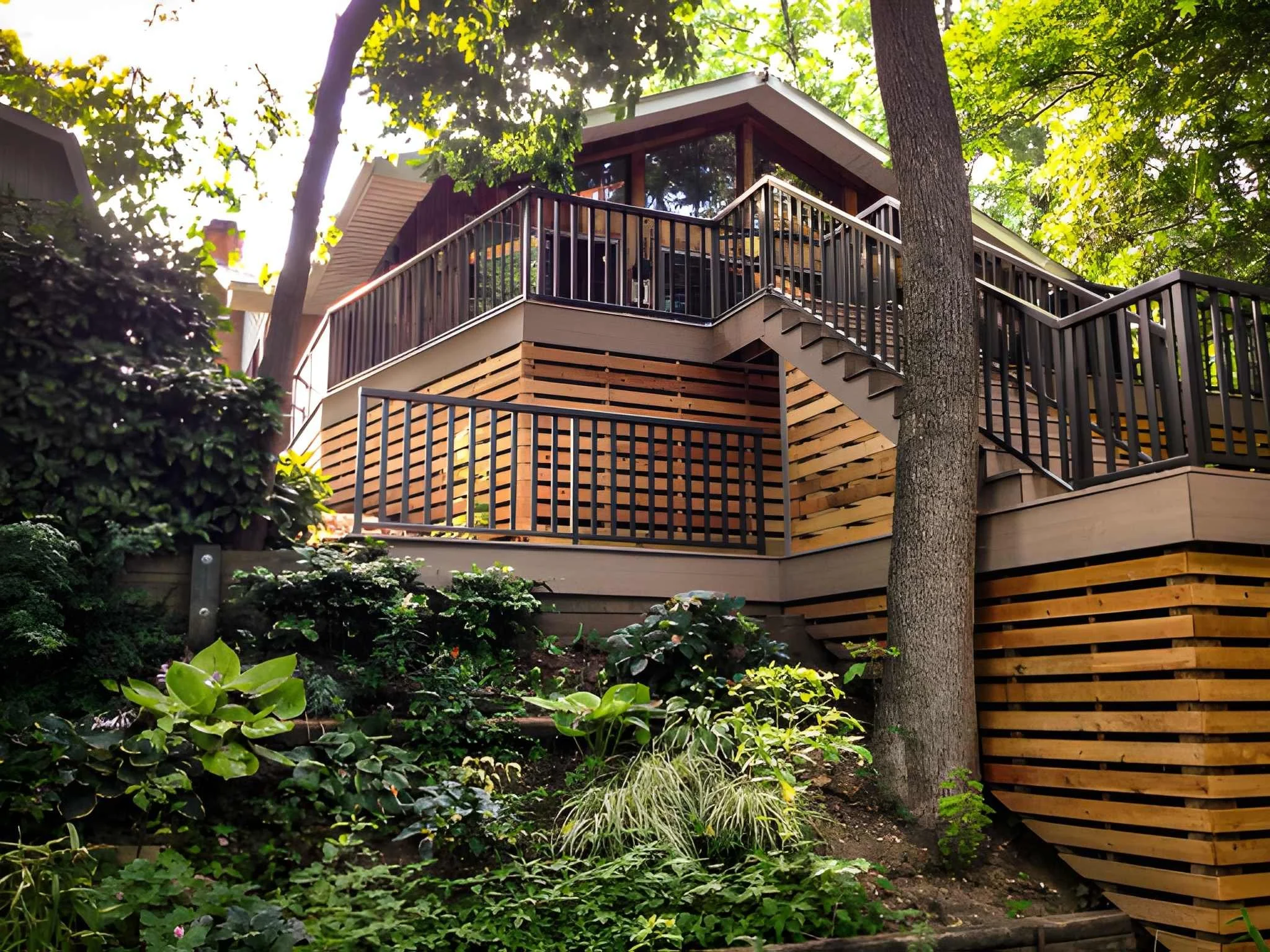 A multi-level house with a wooden and glass exterior, surrounded by lush green trees and plants.