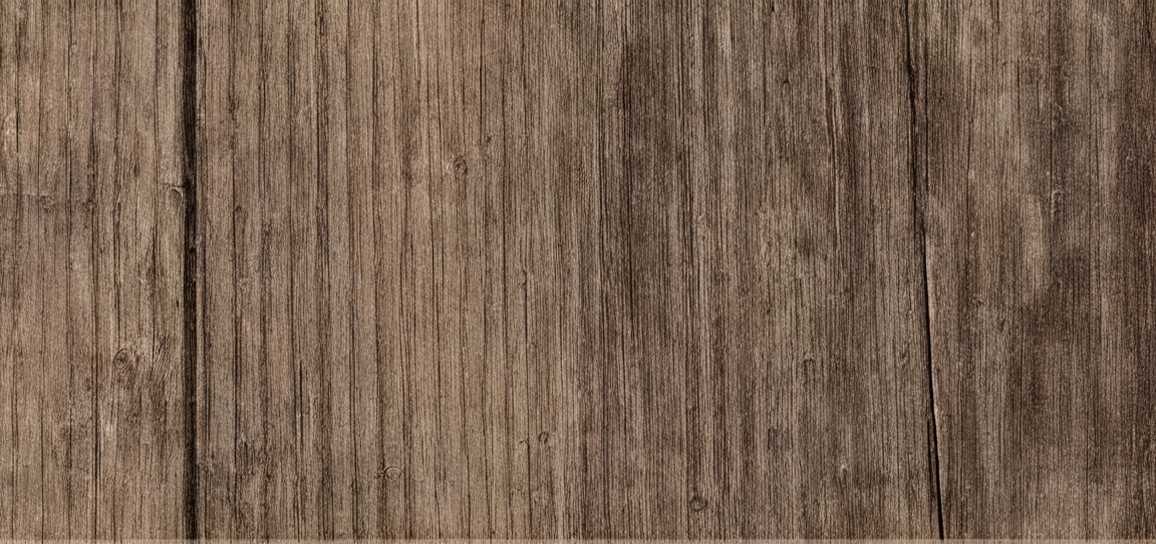 Close-up of a brown wooden surface with visible wood grain and texture.