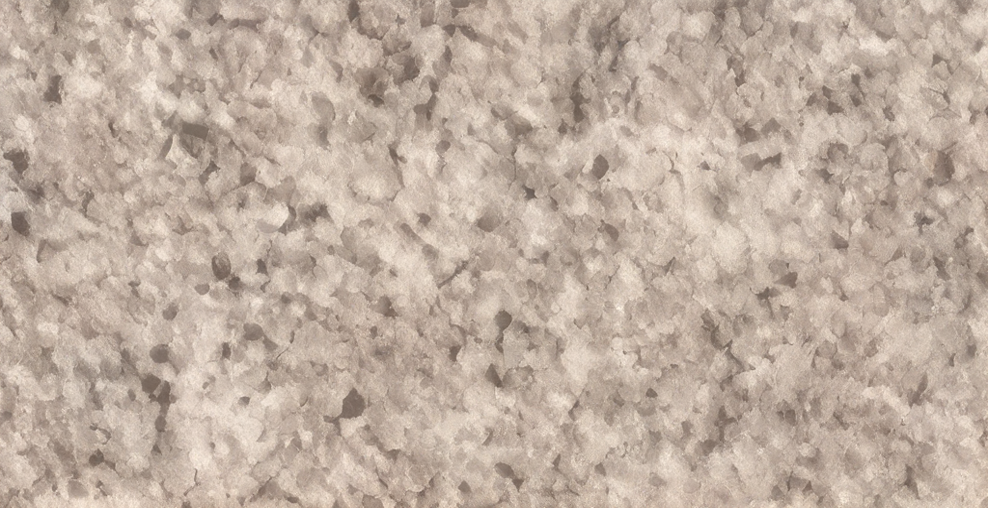 Close-up of a granite countertop with a speckled pattern of gray, white, and black particles.