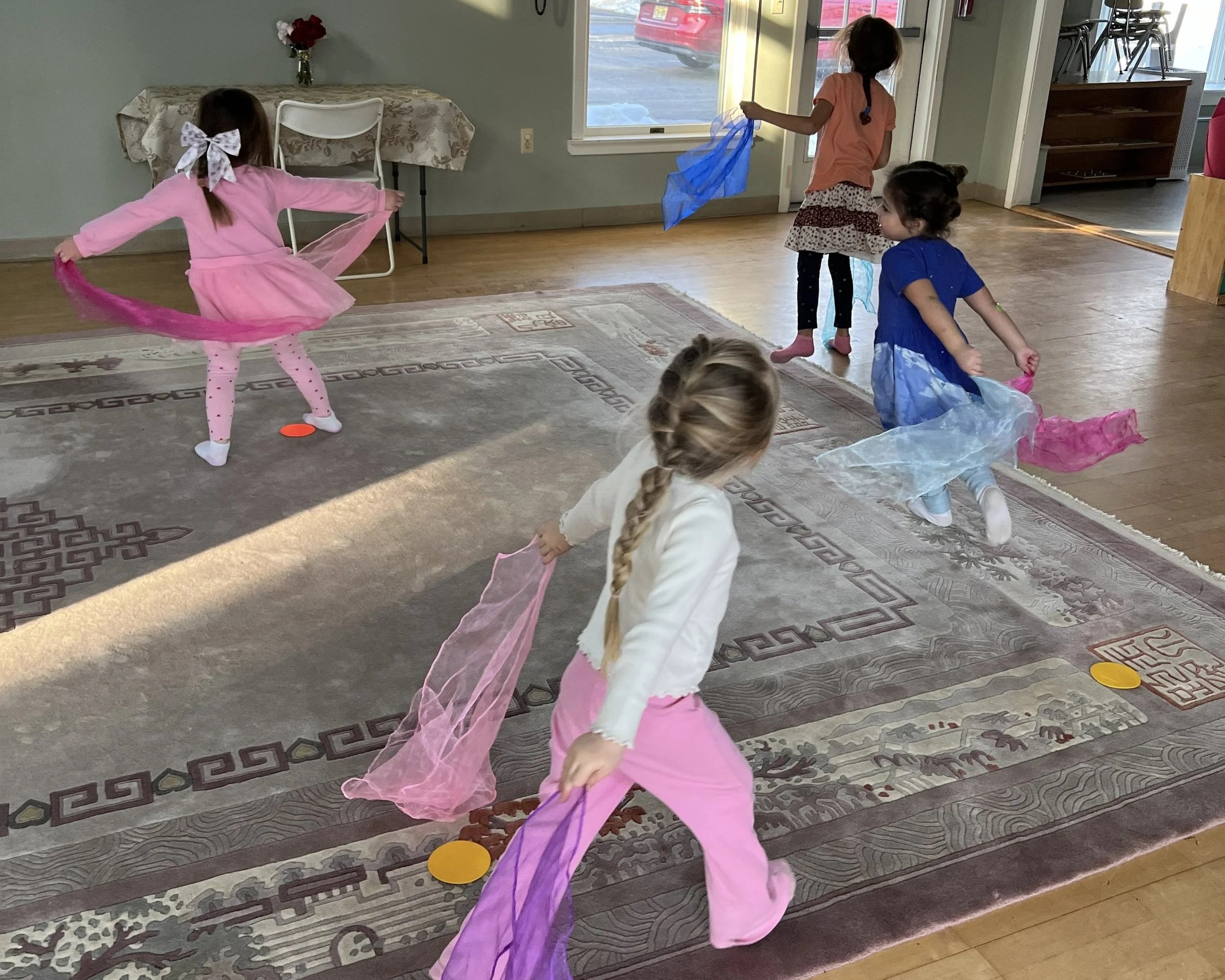 students dancing with scarves