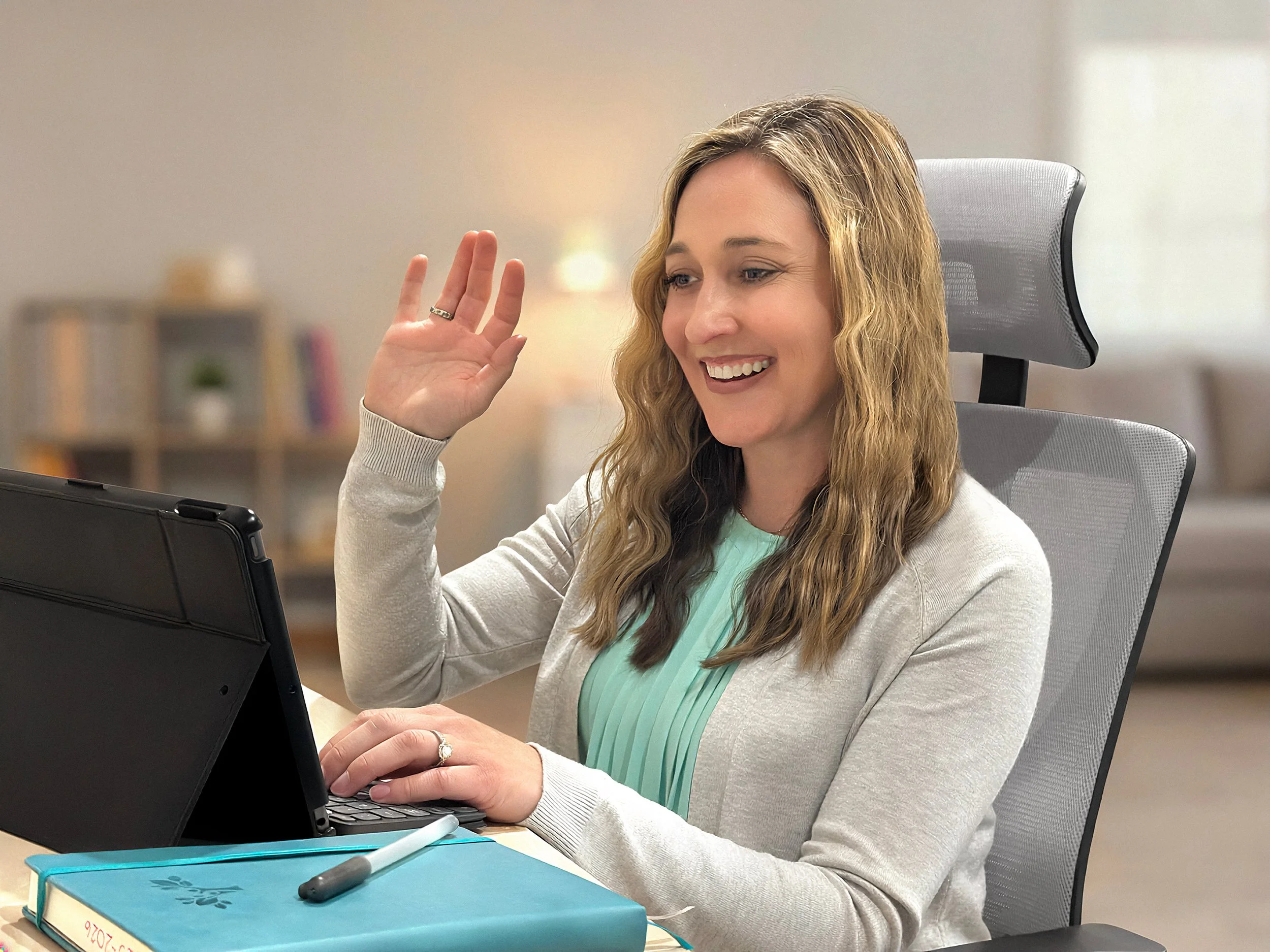 The owner,  Gina, waving to a teacher on her computer