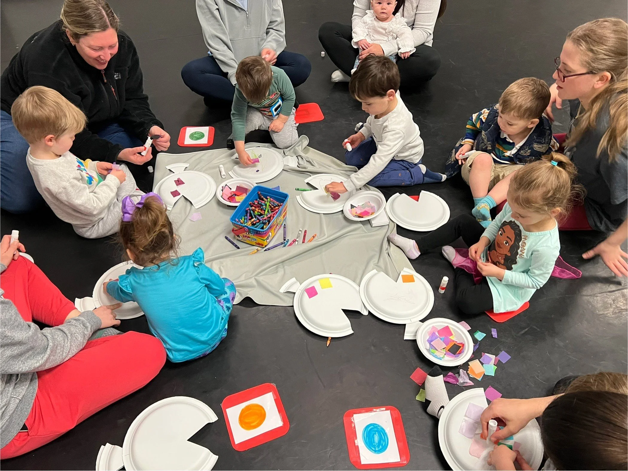 parents and children engaging in a fish craft