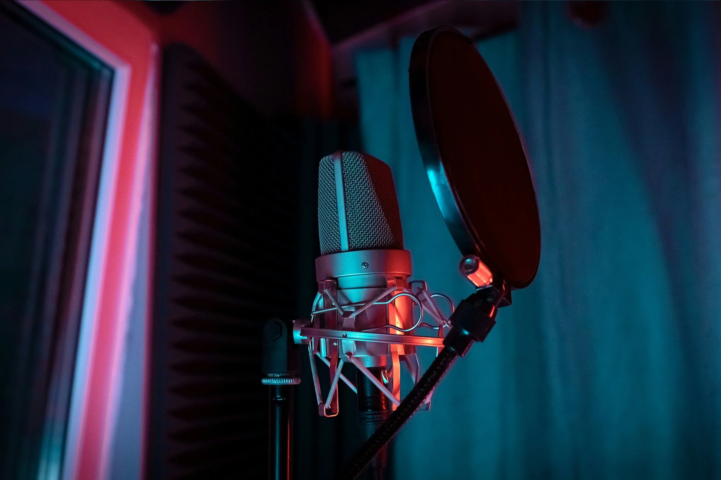 Professional recording microphone with pop filter in a soundproof studio