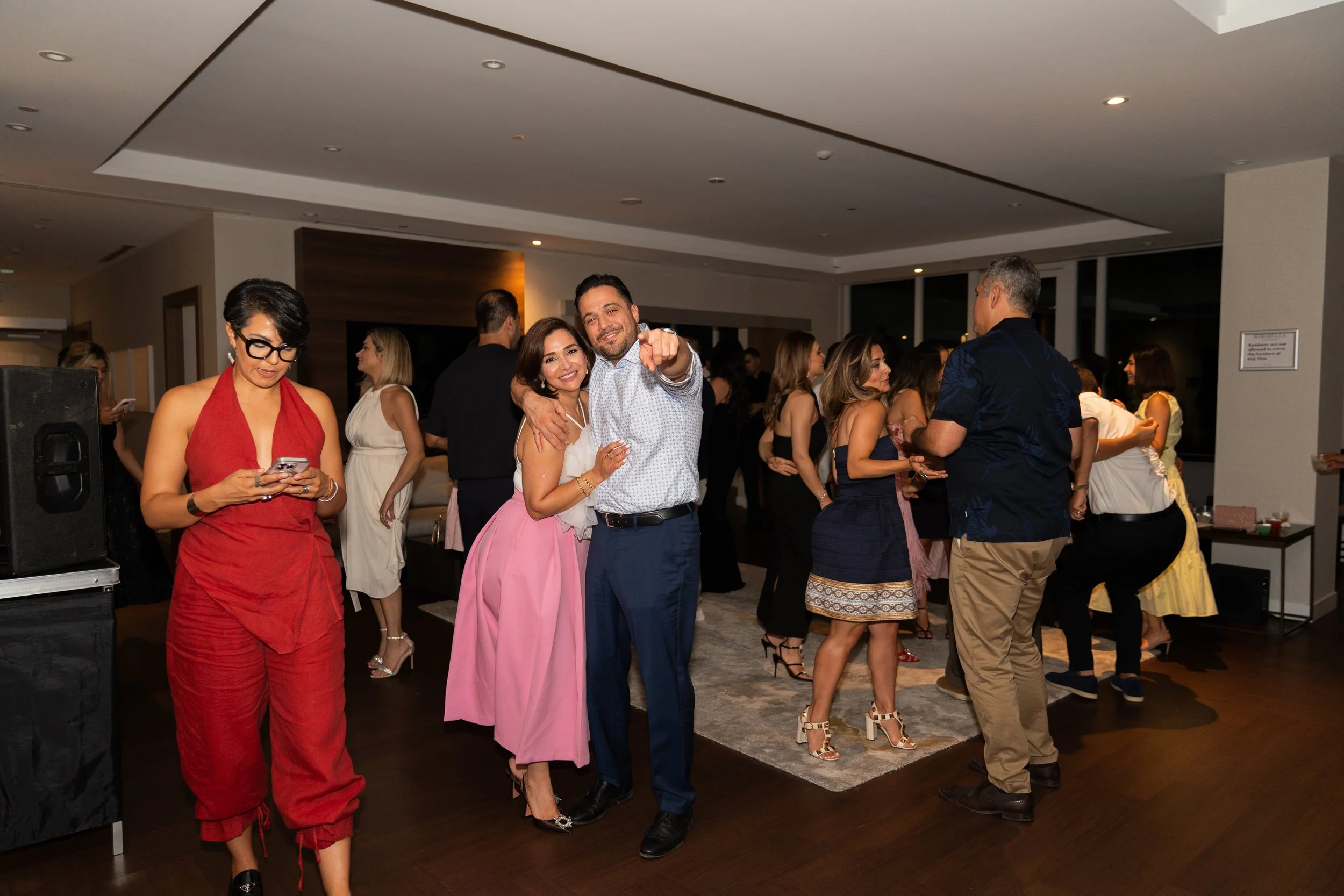 People dancing and socializing at an indoor party or celebration.