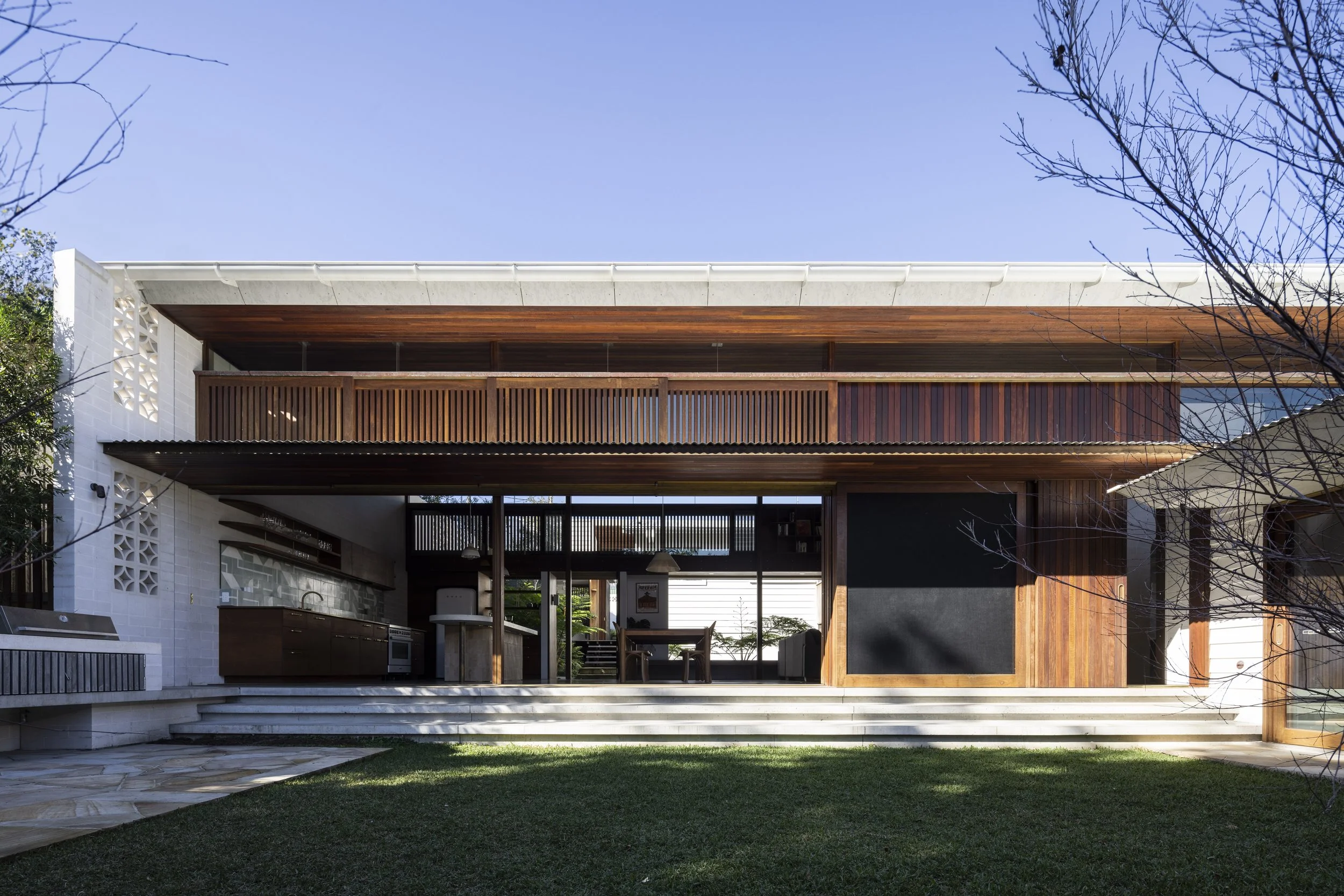 sliding doors and fixed glass shaded by timber batten screens