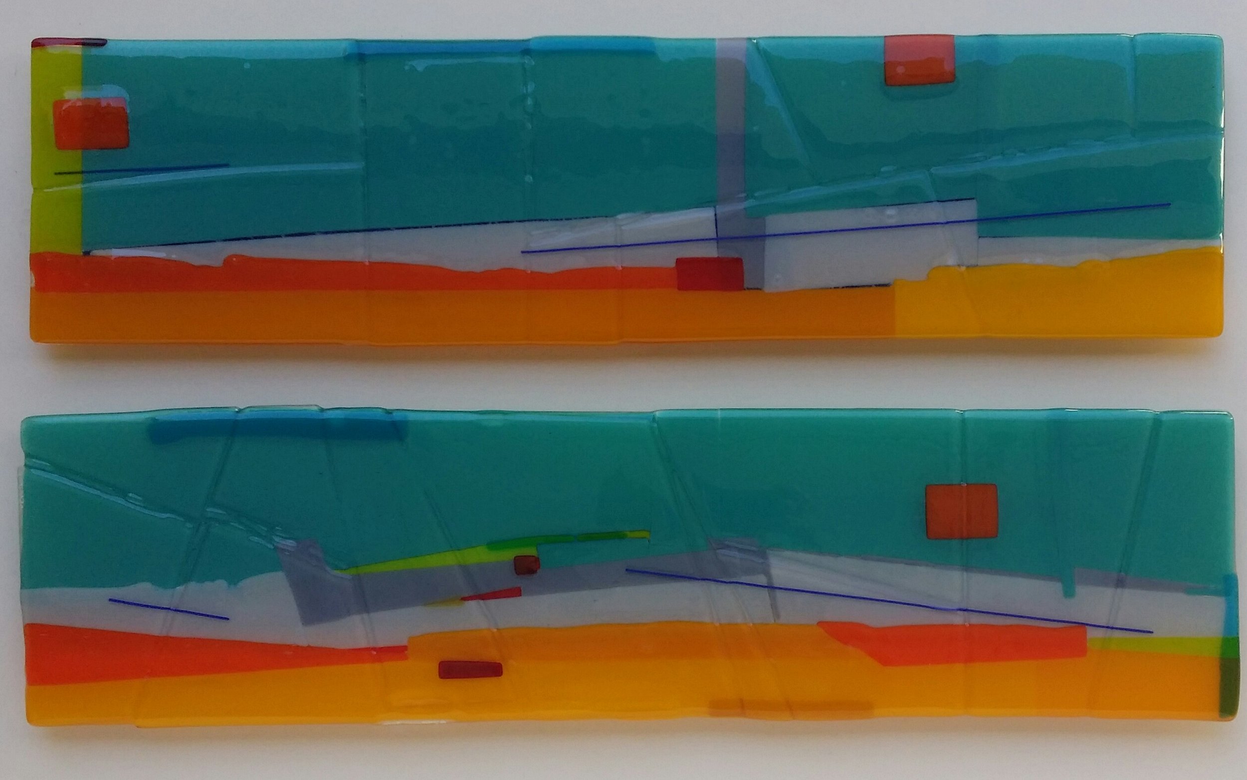 Yolanda Adra Designs. Opalescent glass:  orange, marigold yellow, green, and red accents. Fused glass with dichroic accents.  Each panel:  32W x 8H.  