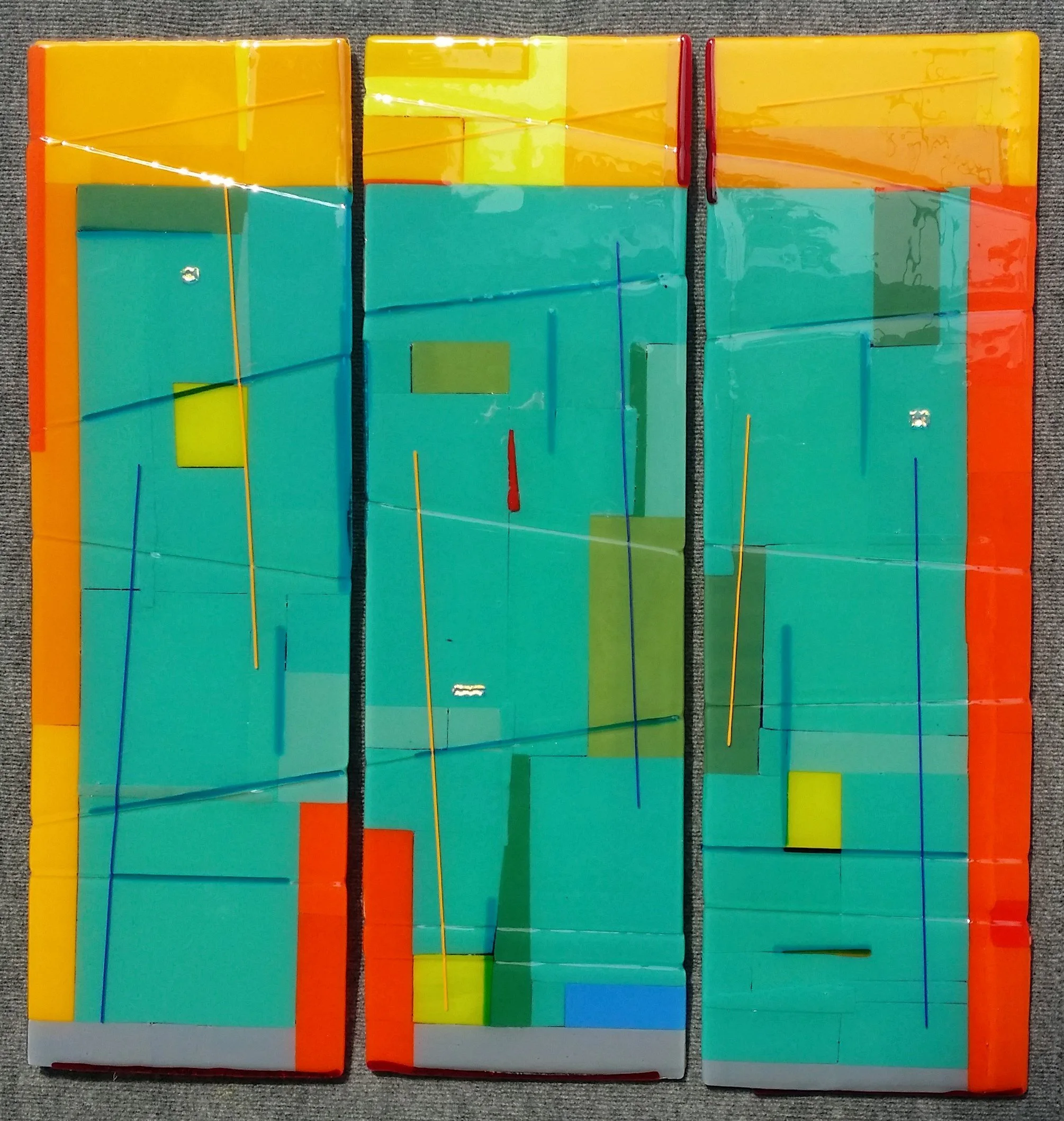 Yolanda Adra Designs.  Opalescent and dichroic fused glass.  Triptych. Each panel: 32H x 10W. 
