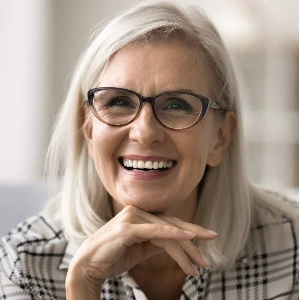 Older woman smiling after restoring her smile with The Smile Restore treatment at Accent Your Dentist in Ponsonby, Auckland.