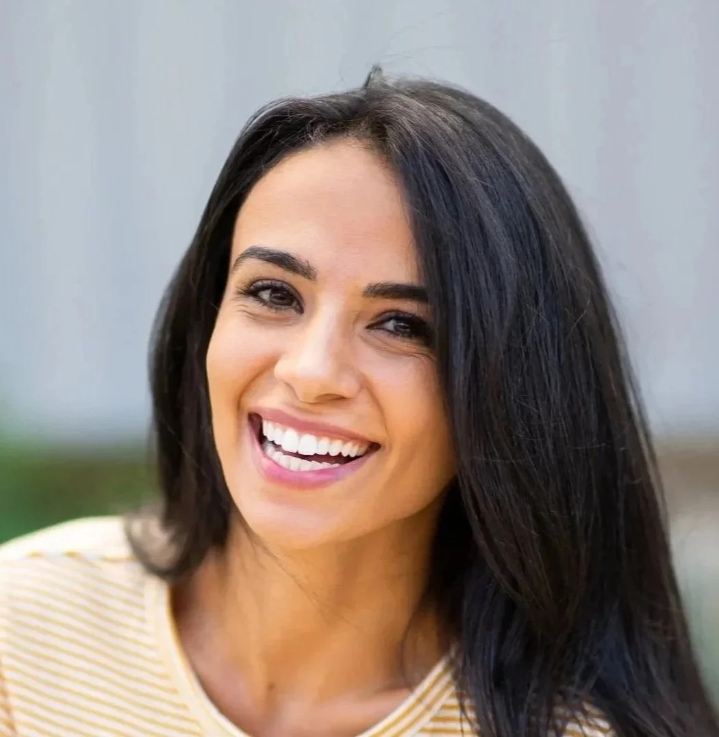 Young woman smiling after cosmetic dentistry at Accent Your Dentist in Ponsonby, Auckland, achieving a brighter, natural-looking smile.
