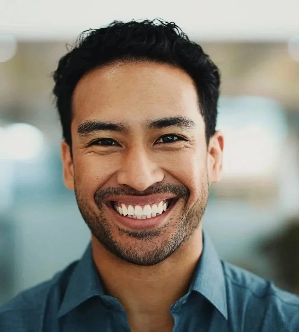 oung man smiling after receiving personalised TMJ treatment and a custom night guard at Accent Your Dentist in Ponsonby, Auckland.