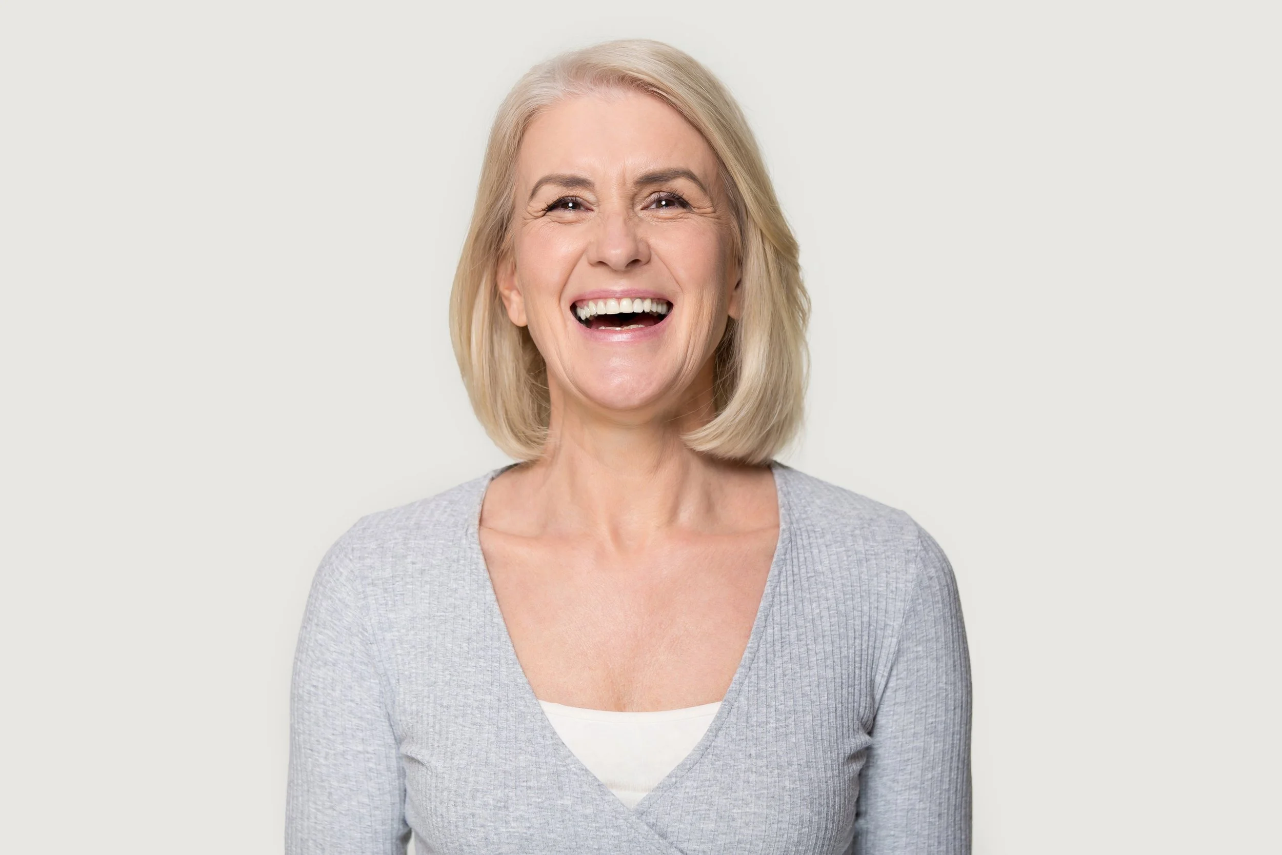 Mature woman smiling after anti-aging dentistry at Accent Your Dentist in Ponsonby, Auckland, creating a healthier, more youthful smile.
