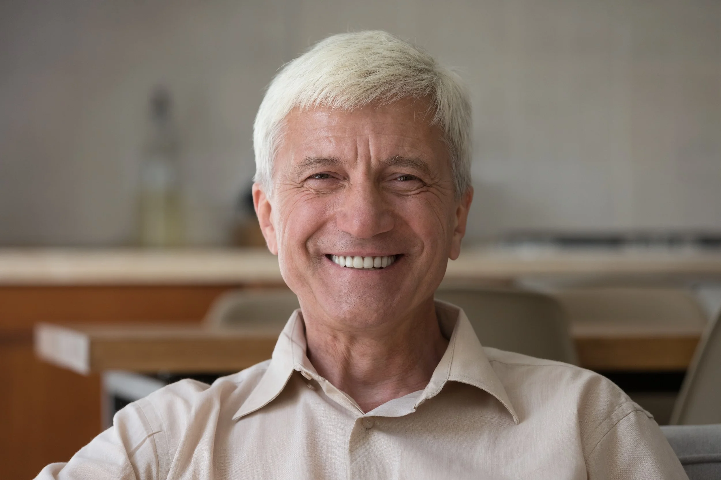 Older gentleman smiling after treatment for a cracked back tooth at Accent Your Dentist in Ponsonby, Auckland.