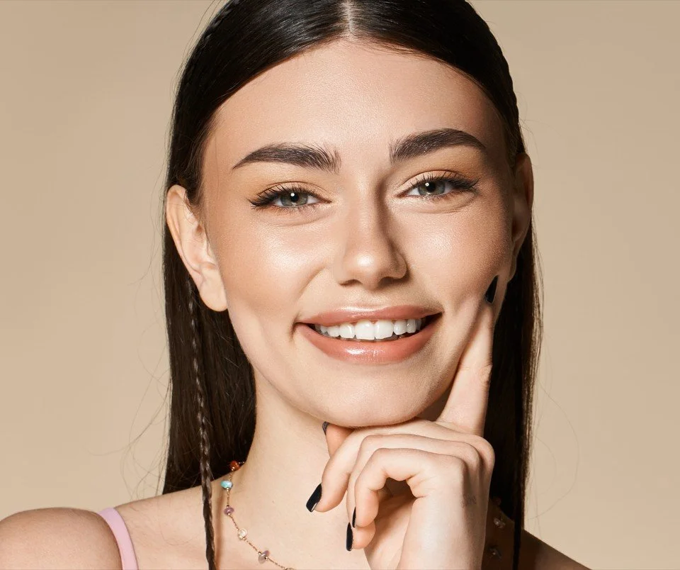Young woman smiling confidently after personalised dental care at Accent Your Dentist in Ponsonby, Auckland.