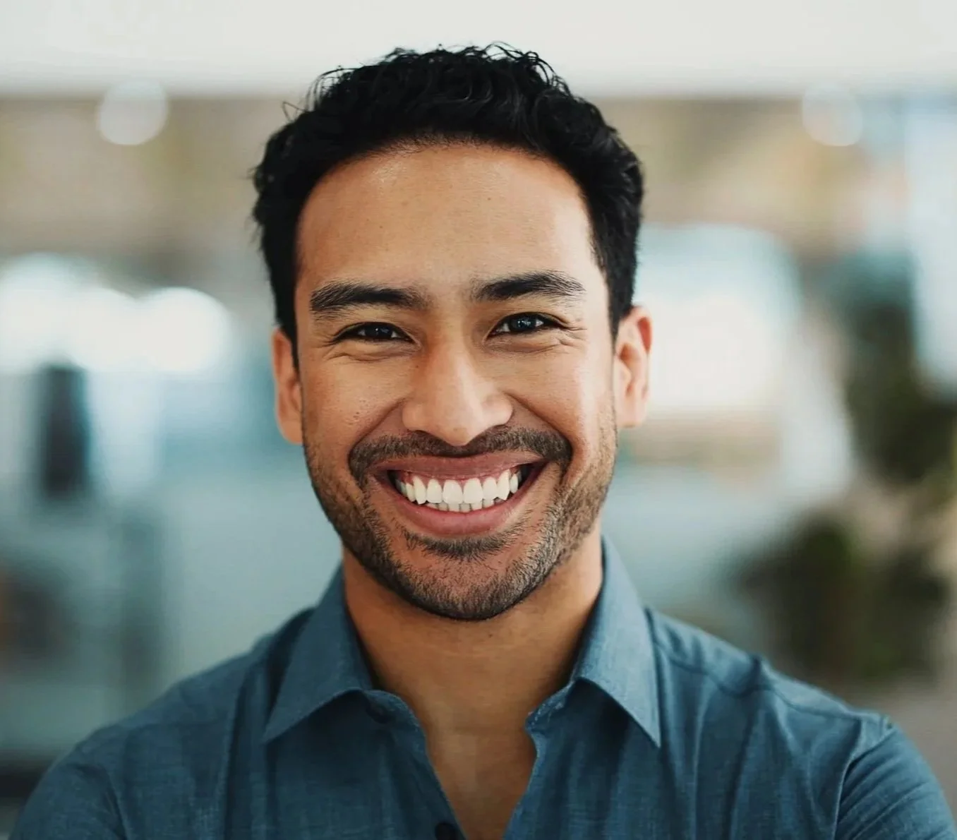Young man smiling after closing a front tooth gap with cosmetic dentistry at Accent Your Dentist in Ponsonby, Auckland.