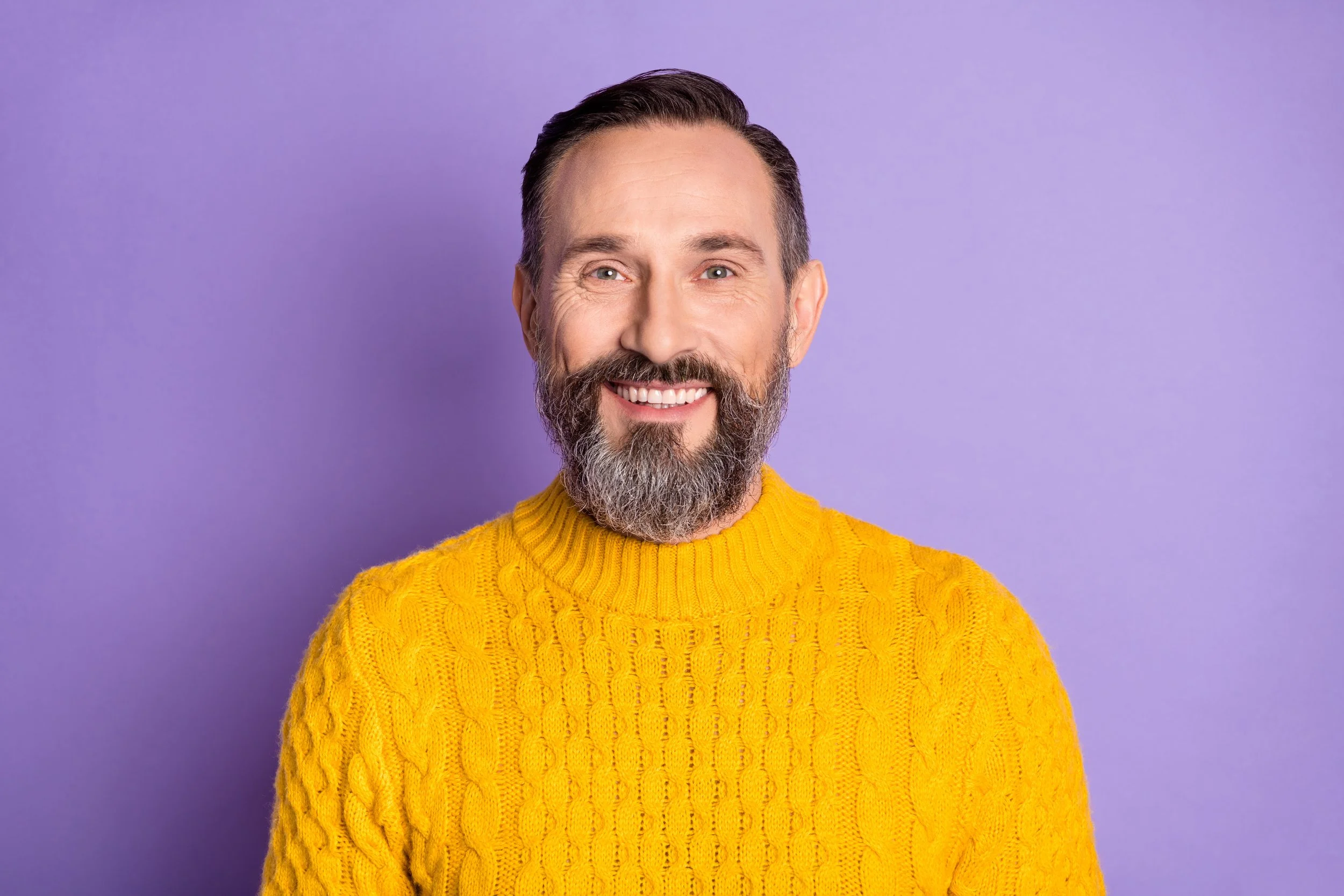 Bearded man in a yellow jumper after a routine dental examination at Accent Your Dentist, supporting long-term oral health.