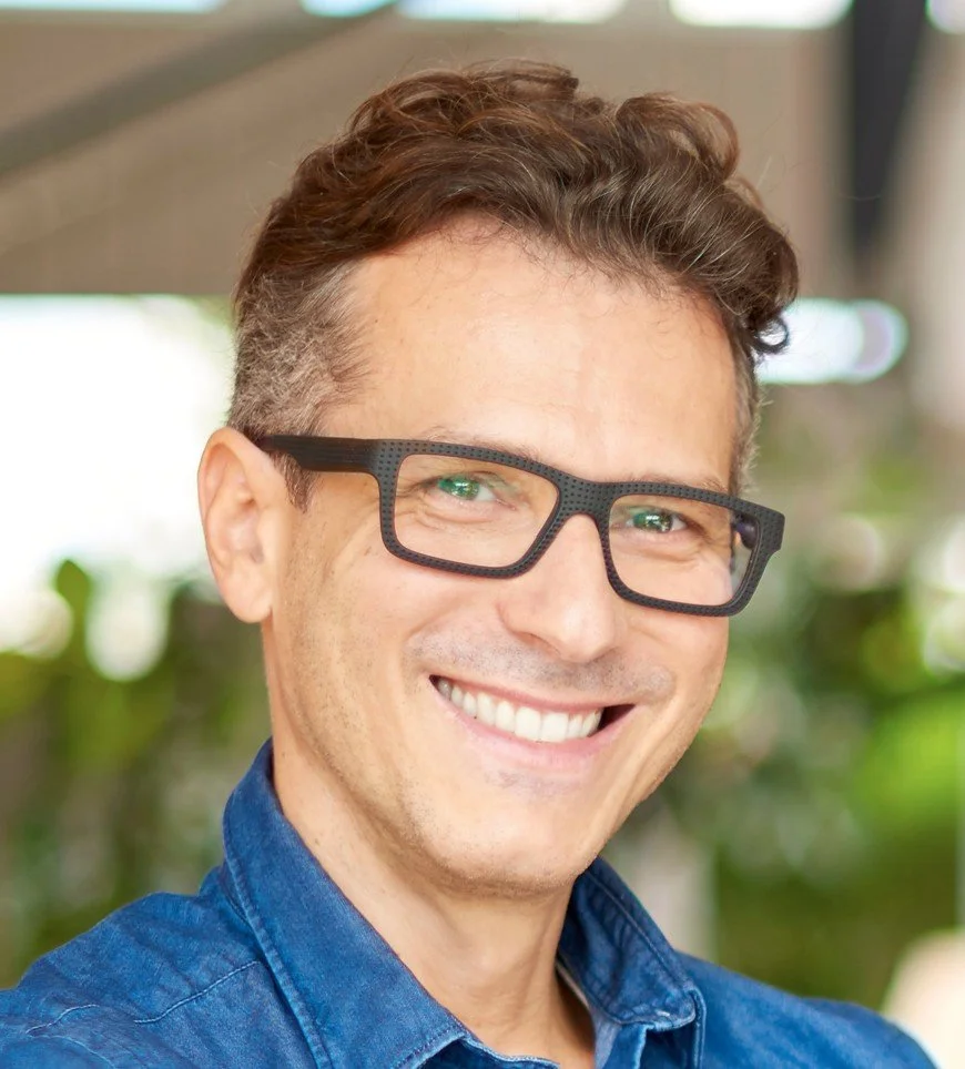 Man with glasses smiling after cosmetic treatment to lengthen small teeth at Accent Your Dentist in Ponsonby, Auckland.