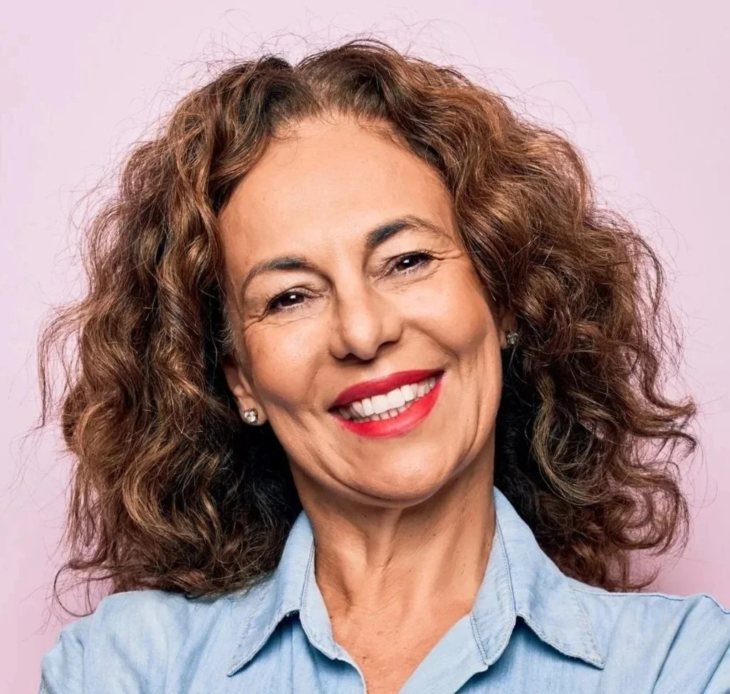 Middle-aged woman with curly hair and glasses discussing her personalised treatment plan at Accent Your Dentist in Ponsonby, Auckland.