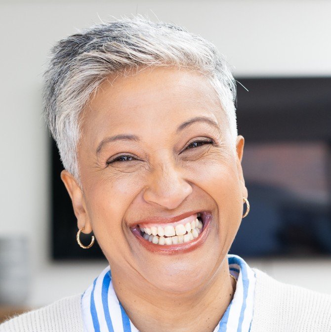 Close-up of a smiling middle-aged woman after restorative dental treatment designed to improve oral health at Accent Your Dentist.