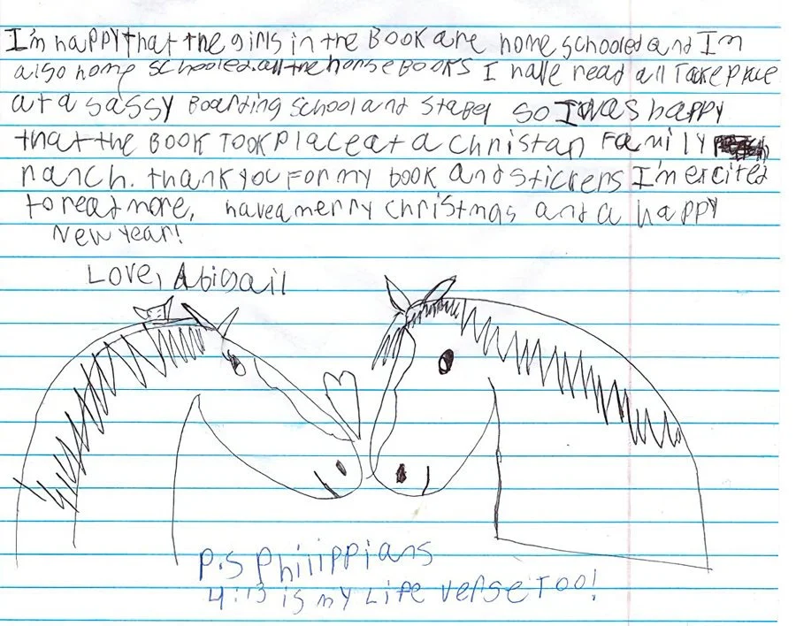 A handwritten letter on lined paper with a drawing of two horses touching noses below the text. The letter expresses happiness about receiving a Christmas gift, a book about horses, and ends with love from Abigail, along with a note about a Philiippi