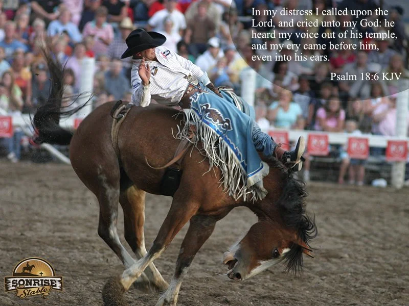 A cowboy dressed in traditional rodeo attire riding a bucking horse in an arena with an audience watching in the background. There is a religious quote from Psalm 18:6 displayed in the upper right corner.