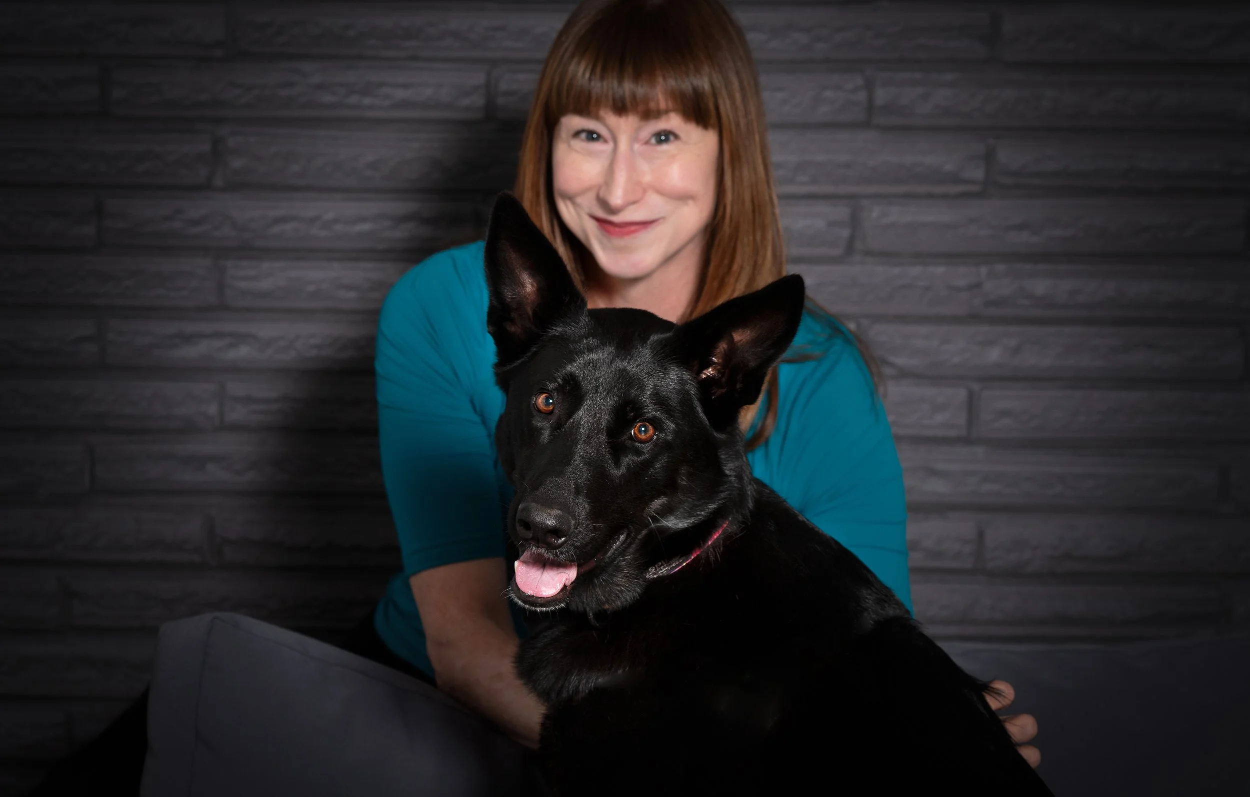 Lou chain, expert Portland Realtor smiles for a photo with her dog.