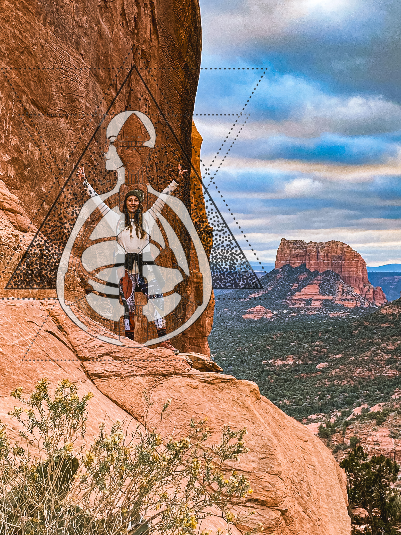 Woman with a climbing harness on a large red rock formation in a desert landscape with distant mesas and a cloudy sky.