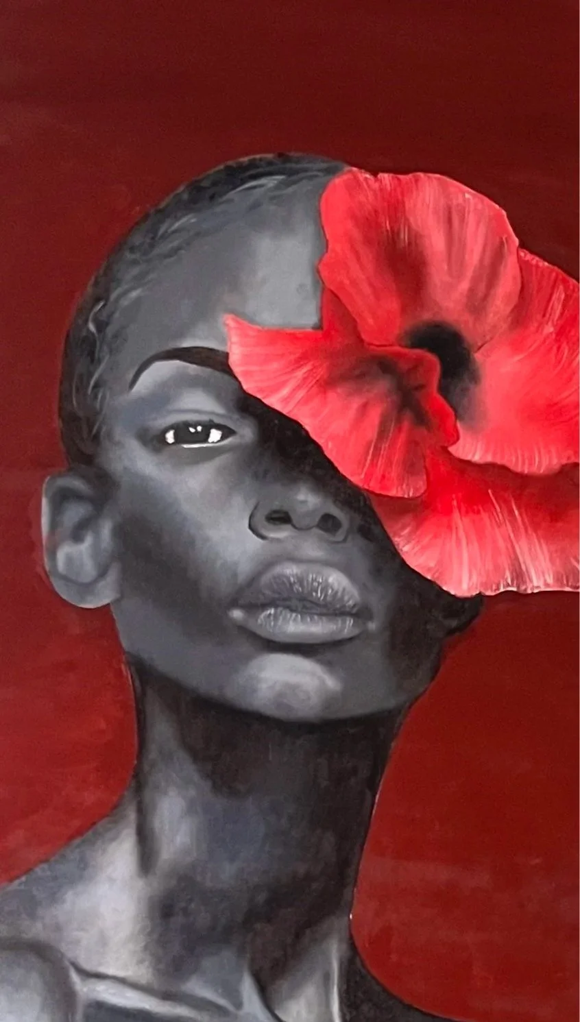 A black-and-white portrait of a woman with a red flower partially covering her face, set against a red background.