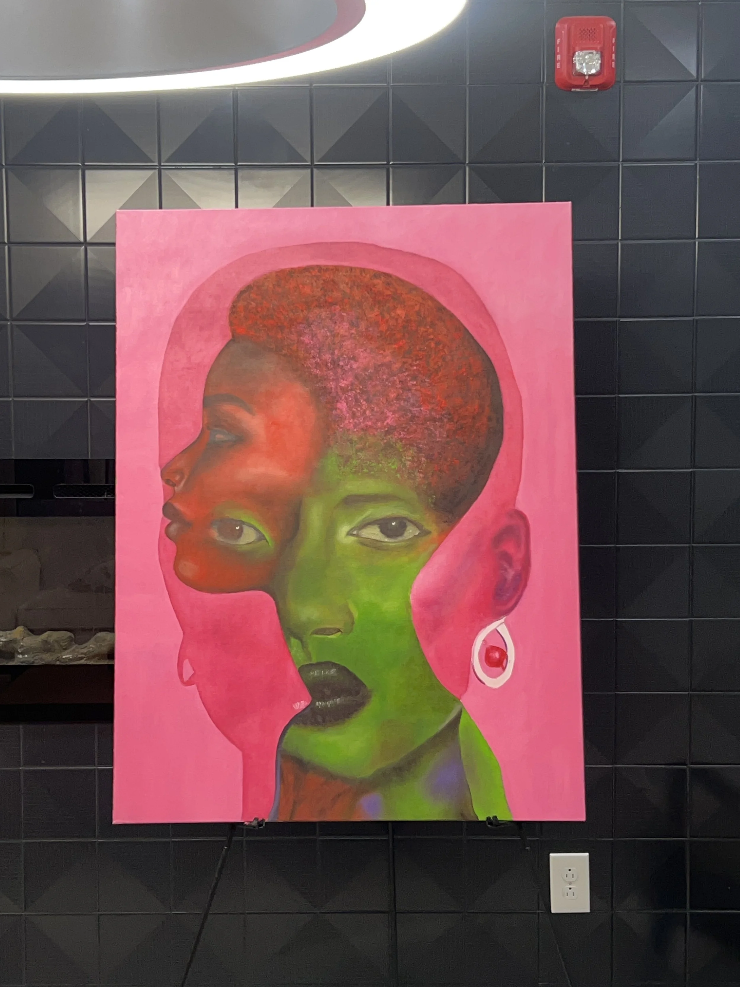 Colorful artwork of a woman with short, textured hair, divided into two halves with contrasting colors, set against a pink background.