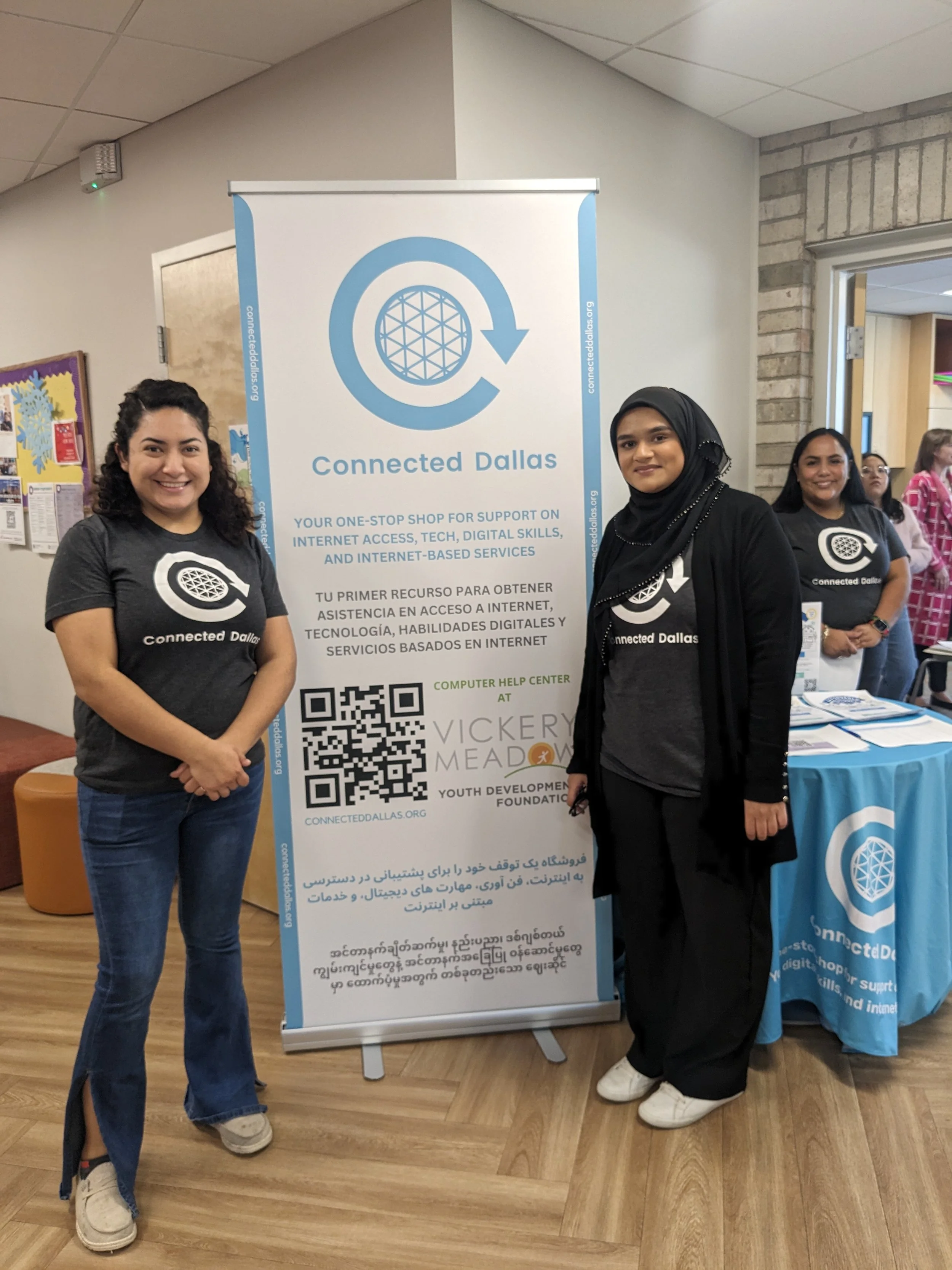 Connected Dallas staff members standing in front of Connected Dallas sign