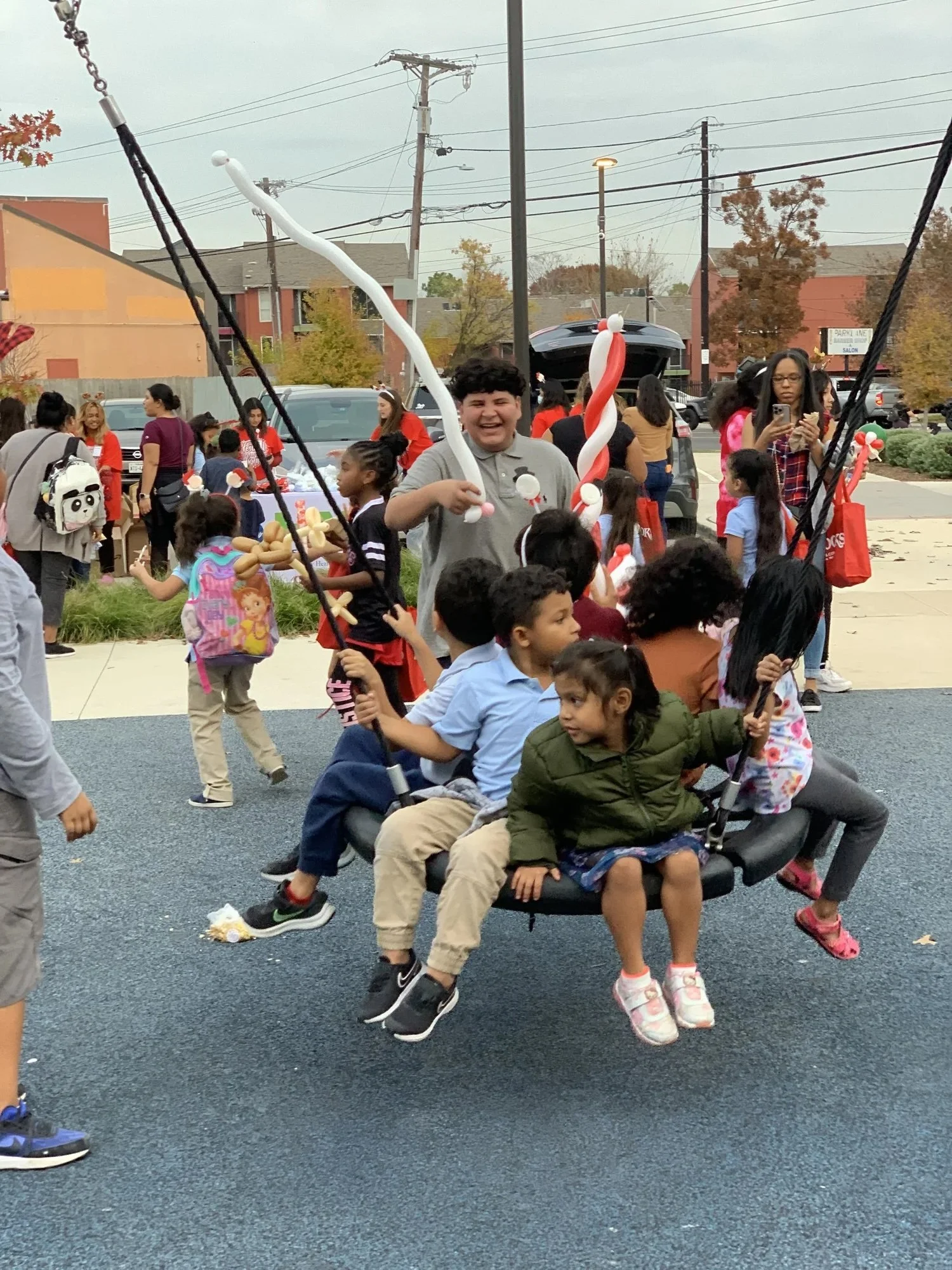 many students on a tire swing