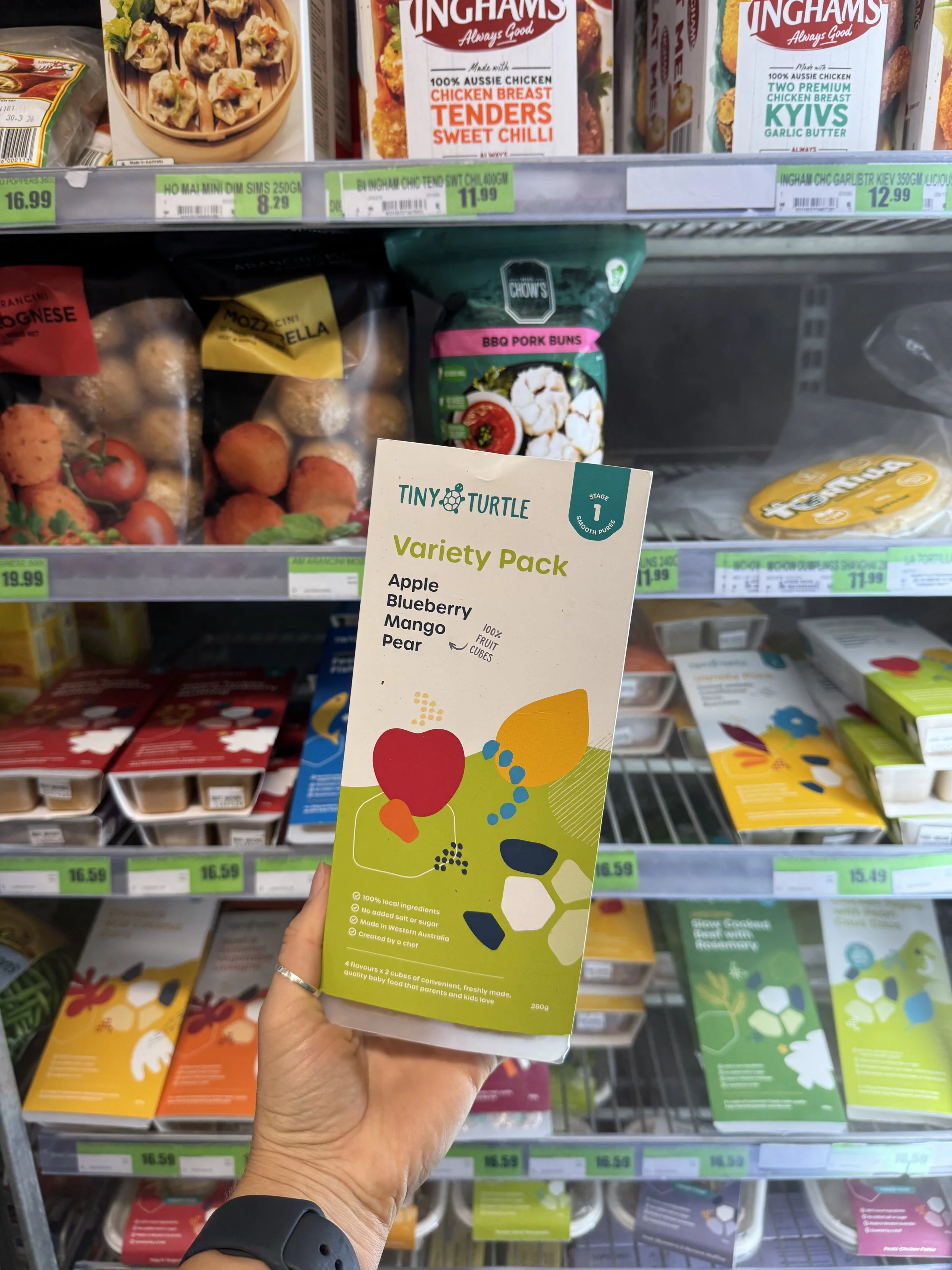 Frozen meals, vegetables and ice cream selection in supermarket freezer aisle