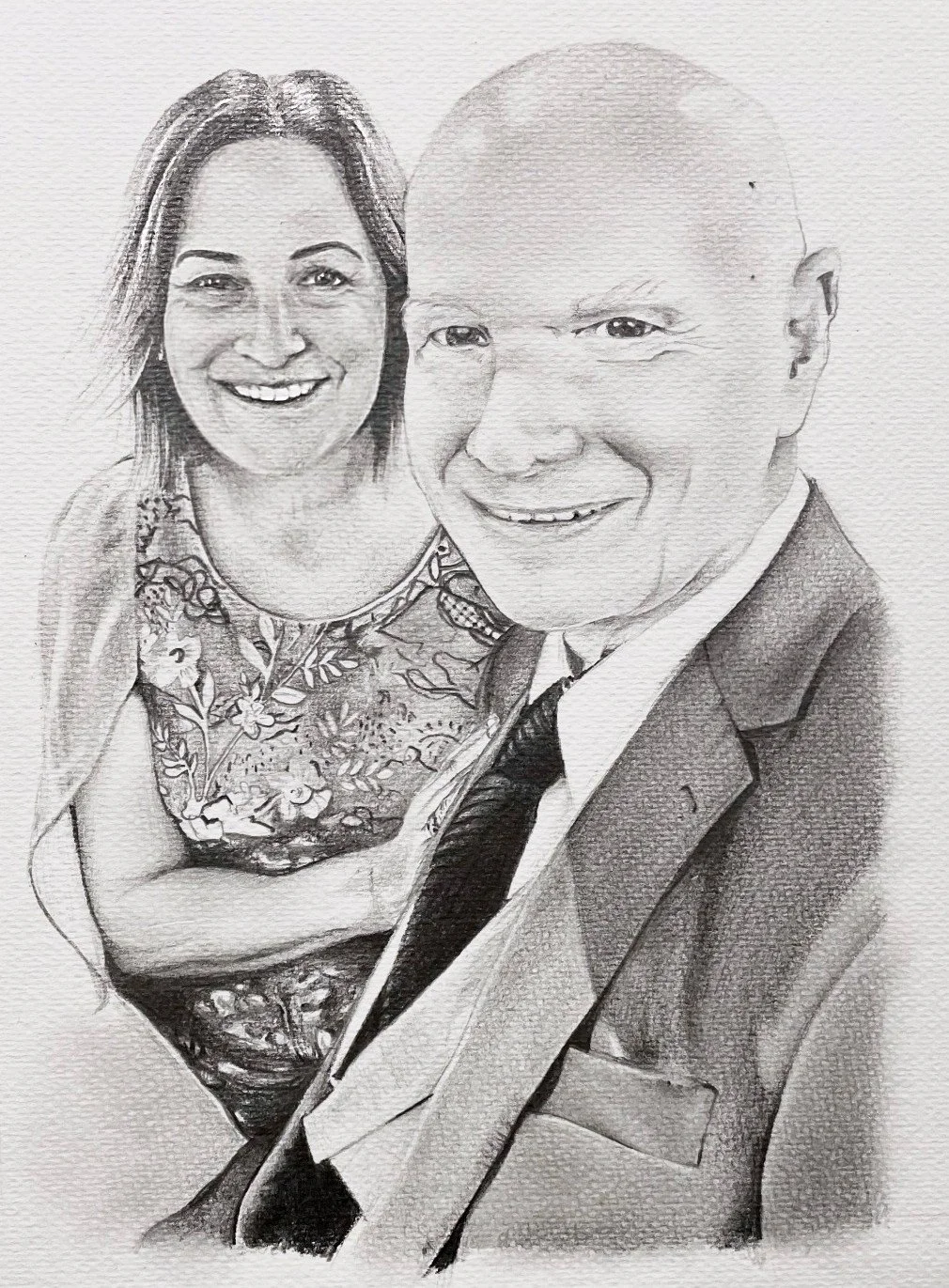 Black and white sketch of a smiling woman and man, woman wearing a floral dress and the man in a suit with a tie.
