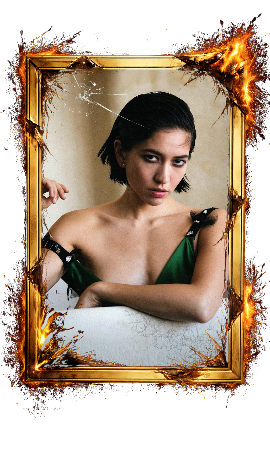 A woman with short black hair and wearing a green dress with black embellishments is sitting in front of a beige wall, looking at the camera. The image has a digital frame that appears to be burning or cracked.