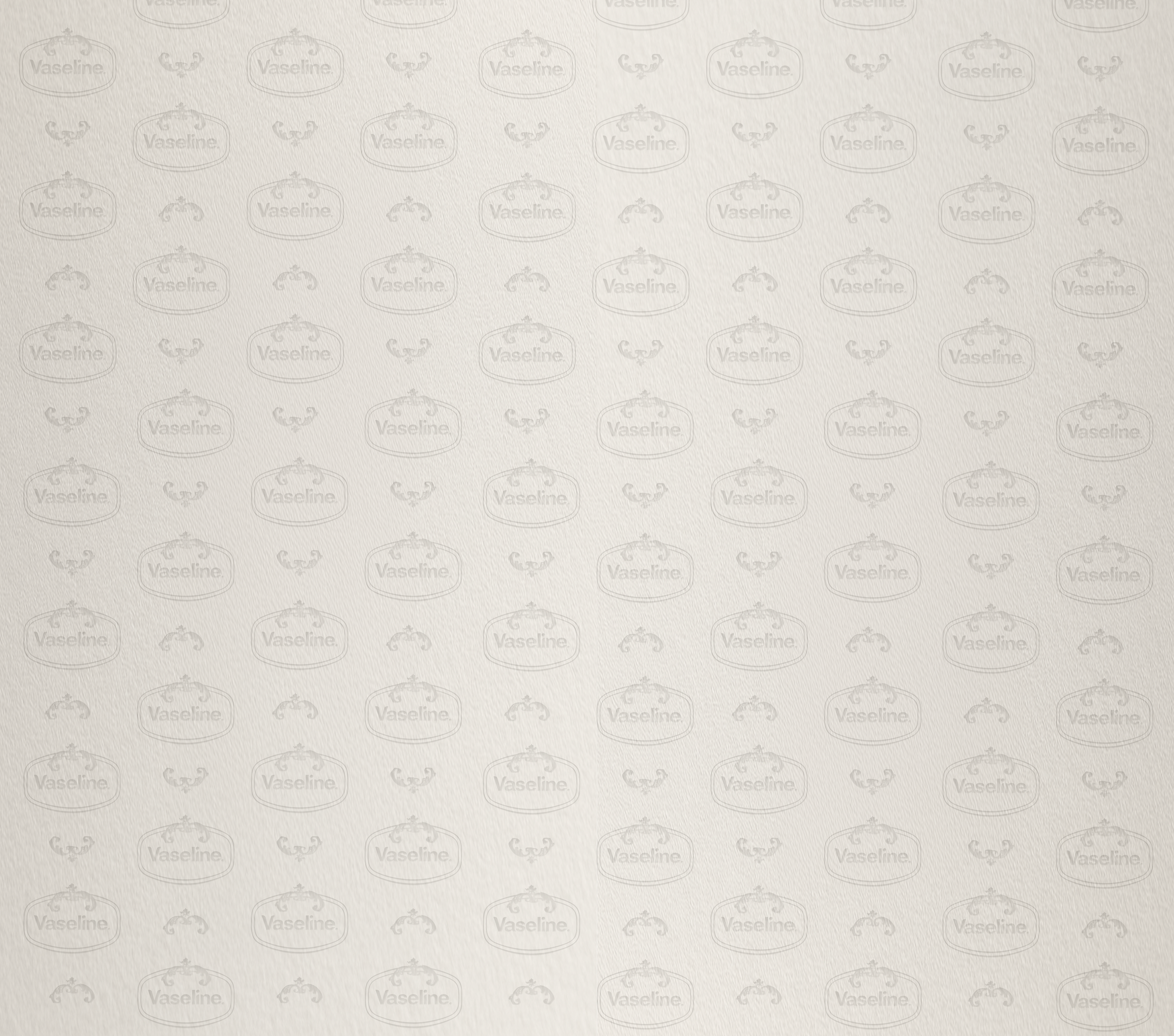 An empty, beige-colored surface with a textured pattern and faint Vaseline logos repeated across it.