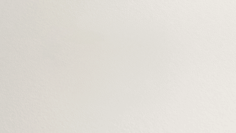 A blank, textured beige wall.