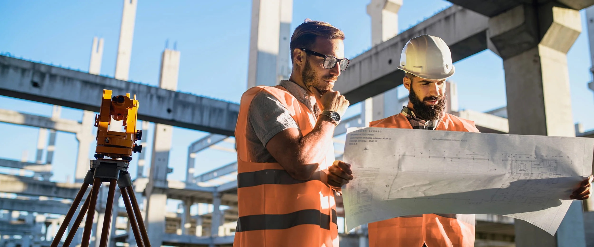 Engineers reviewing civil infrastructure plans on-site