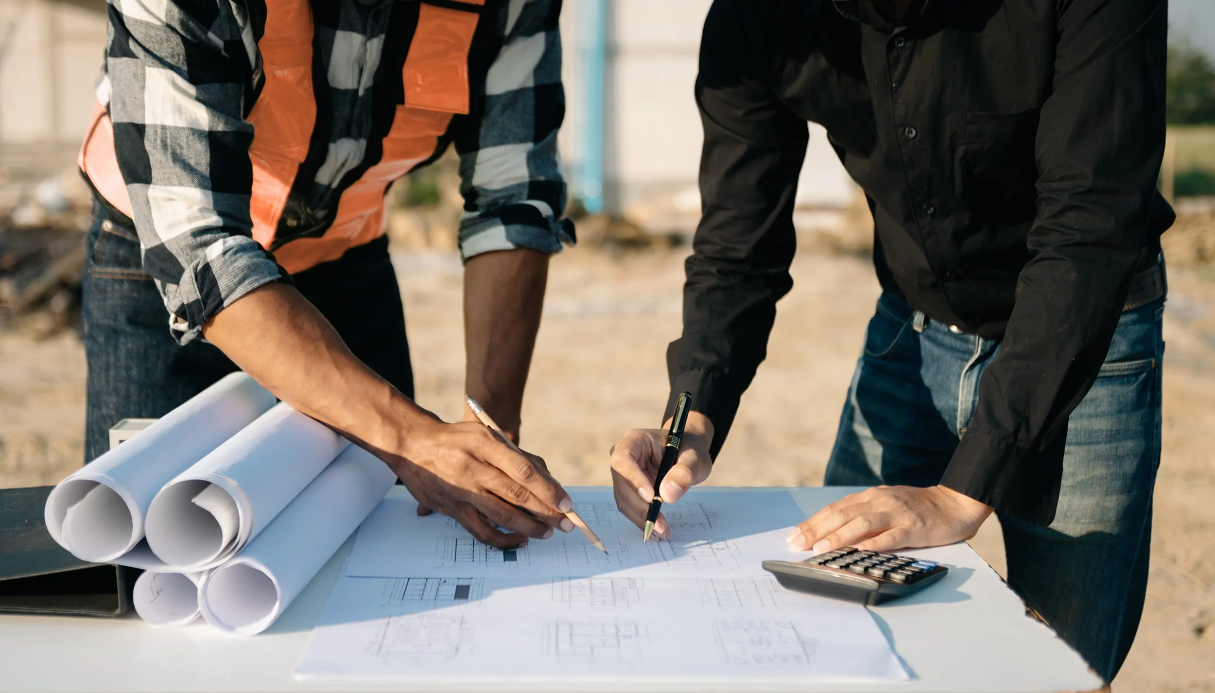 Engineers reviewing civil infrastructure plans on-site